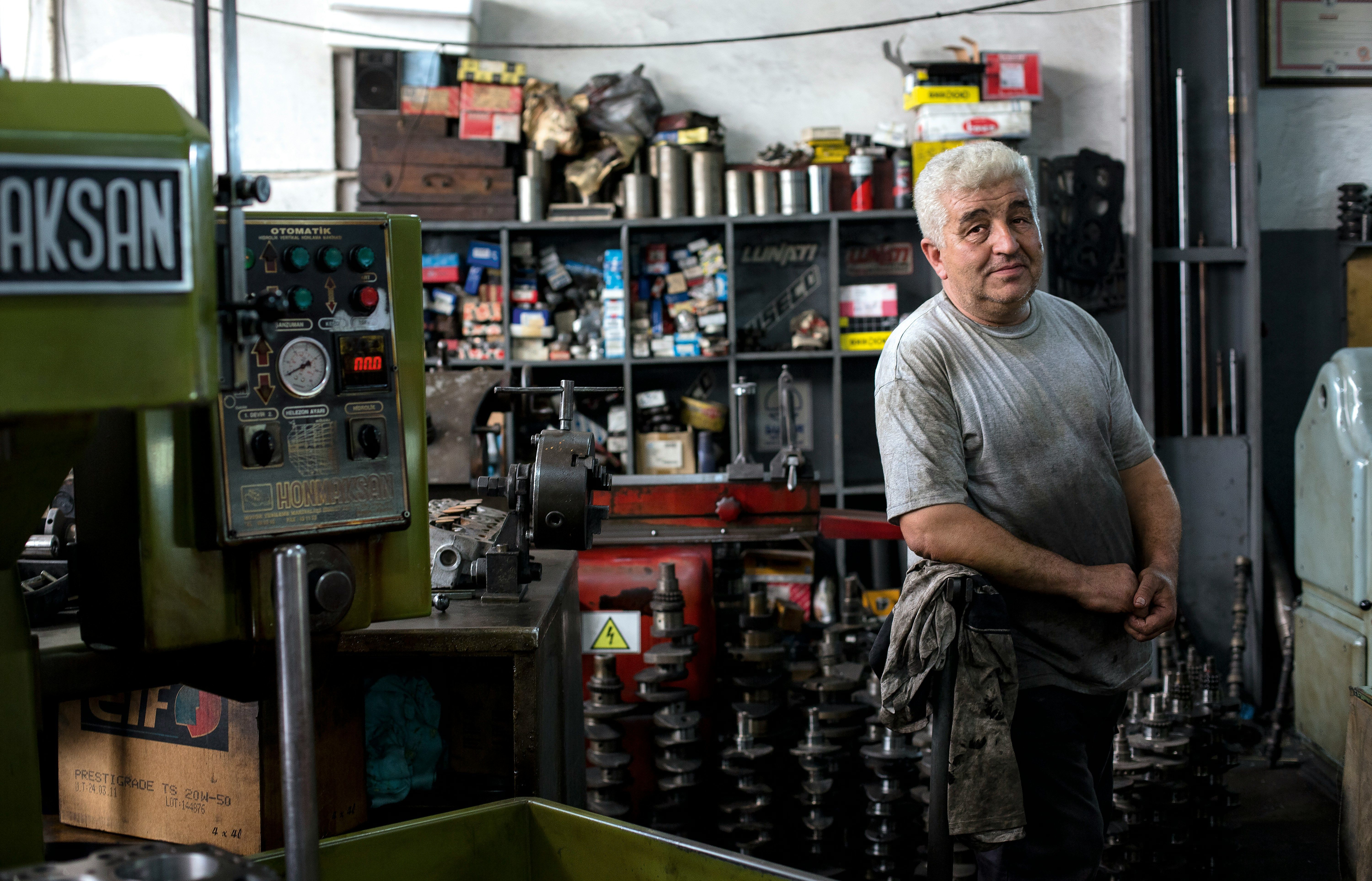 Small business owner in auto body shop by Alev Takil.