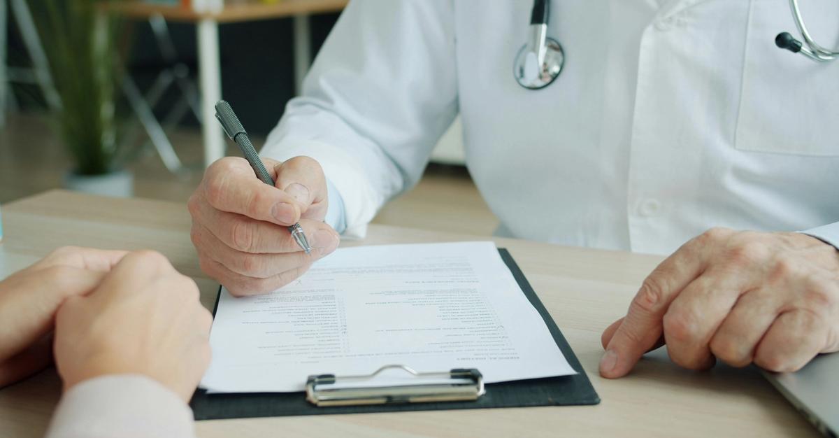 Medical doctor reviewing medical bills.