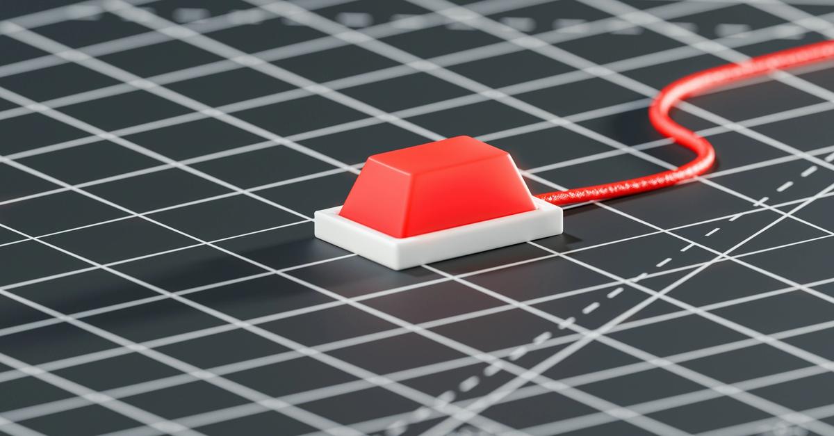 Red button on a black and white grid.