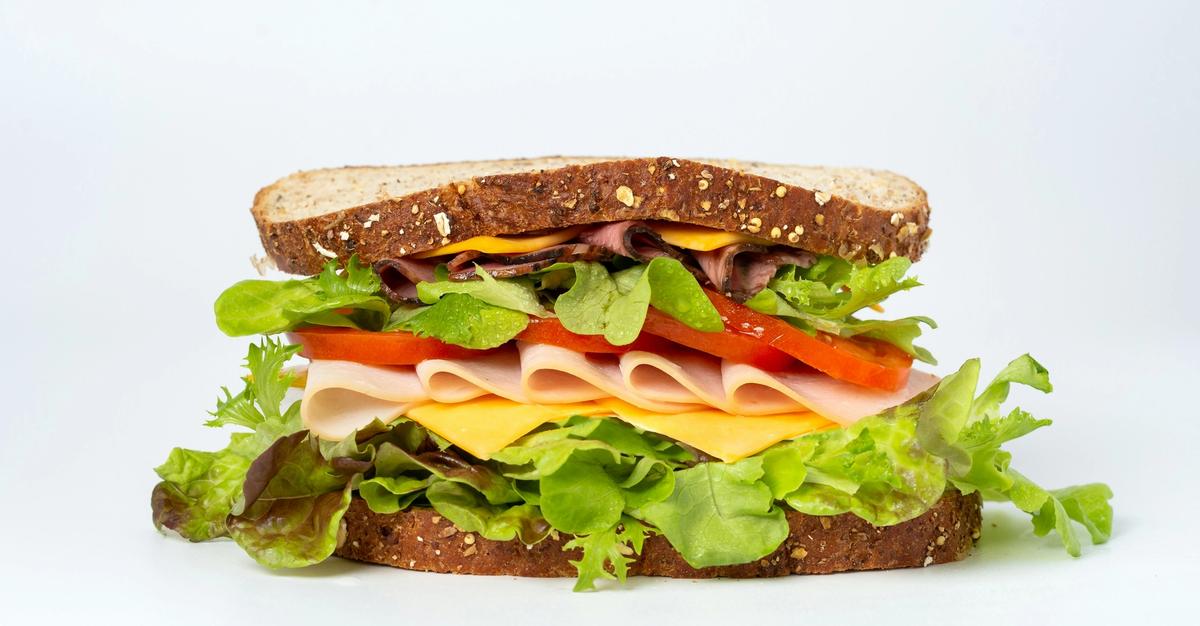 Sandwich sitting on a white back by mae mu.