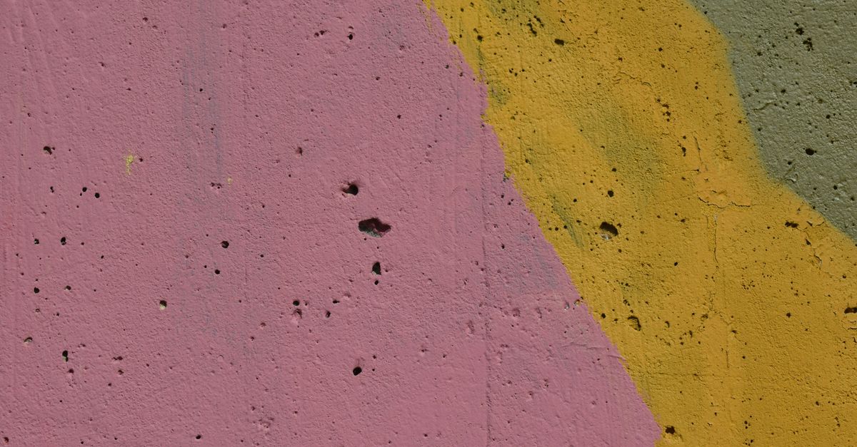 Pavement painted in pink, yellow and green.