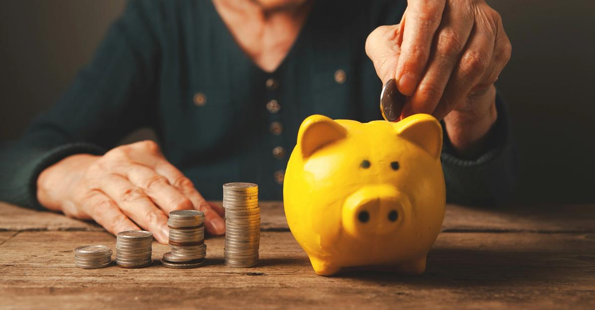 Retiree putting funds into a piggy back by sasun budgdaryan.