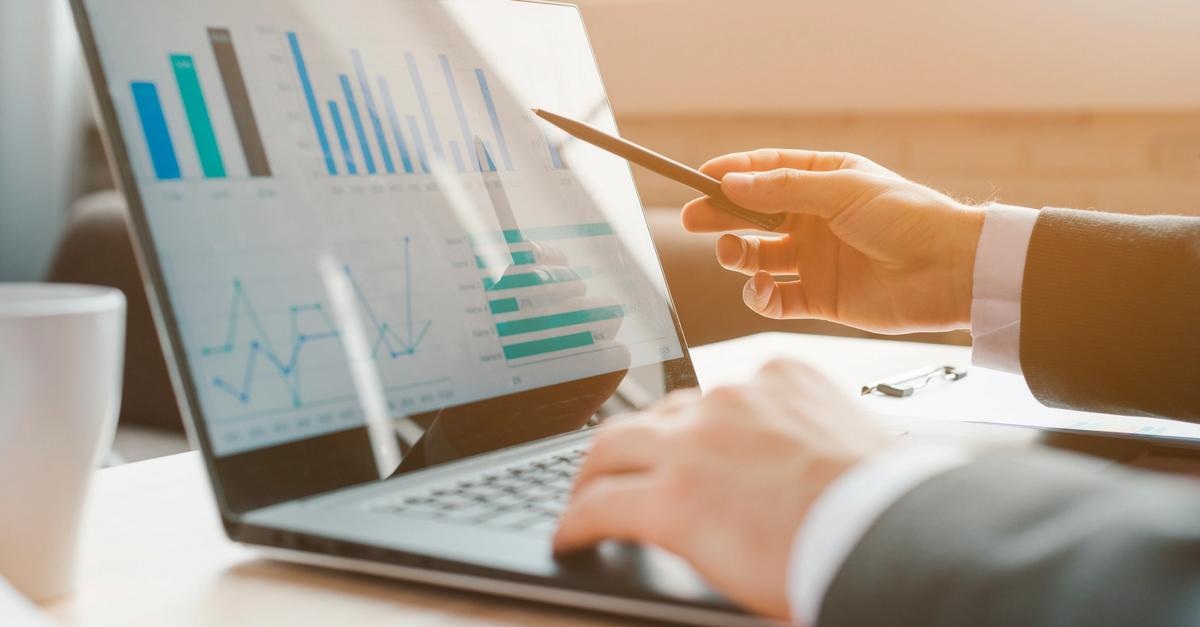 Laptop showing graph reports by Loui Kiaer.