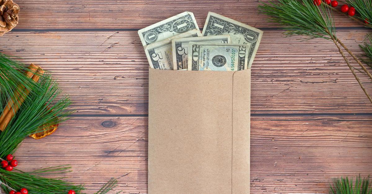 Savings envelope filled with money by Micheile Henderson.