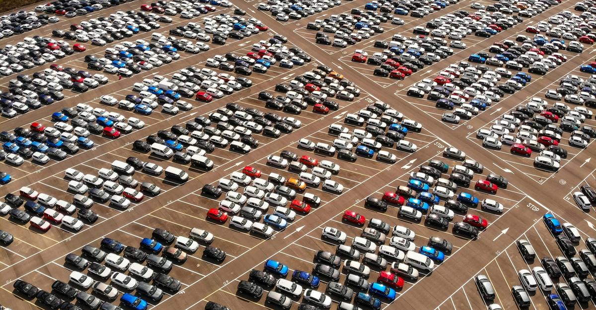 Different assorted color vehicles in car lot by Carles Rabada.
