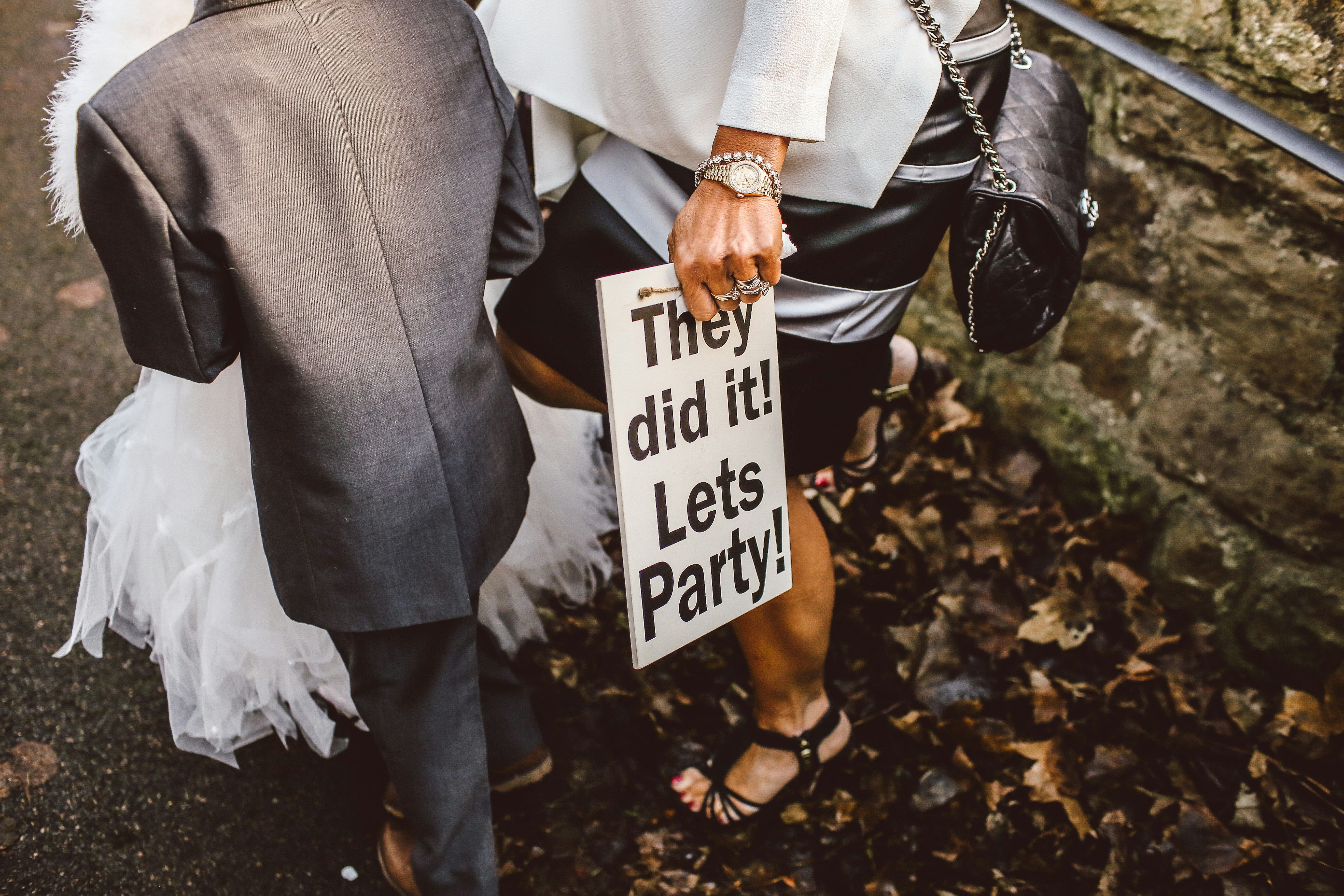 After wedding sign saying "They did it! Lets party!" by Thomas William