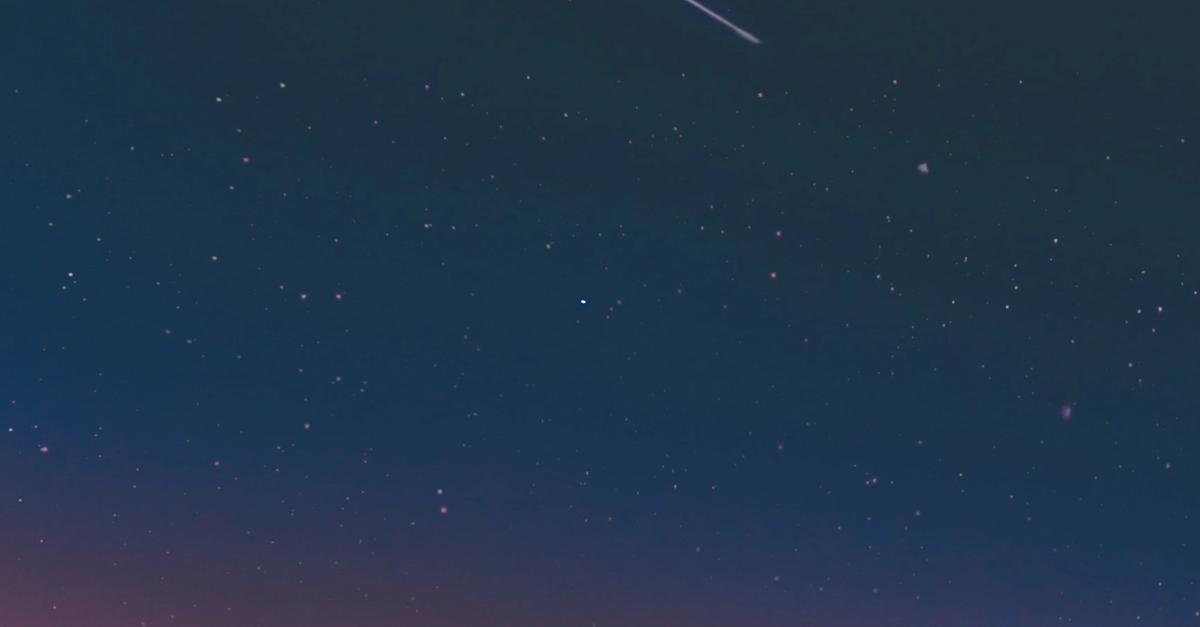 A shooting star in the night sky.