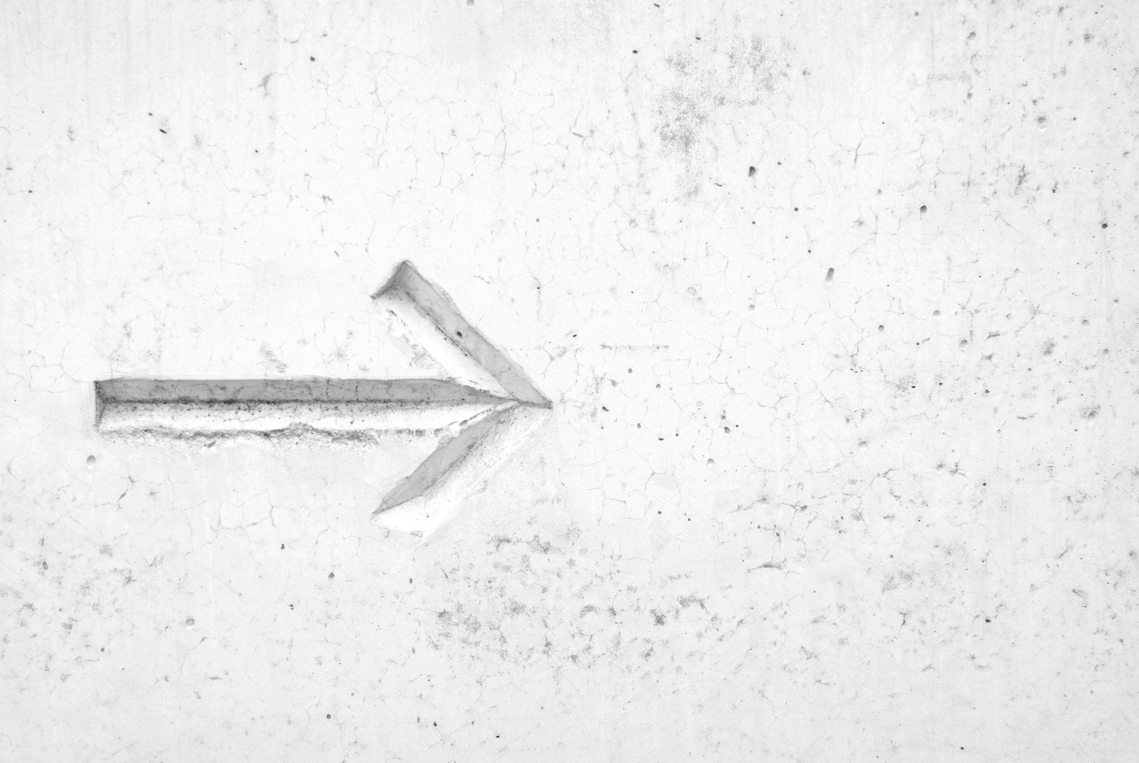 Arrow pointing to the right with white backdrop.