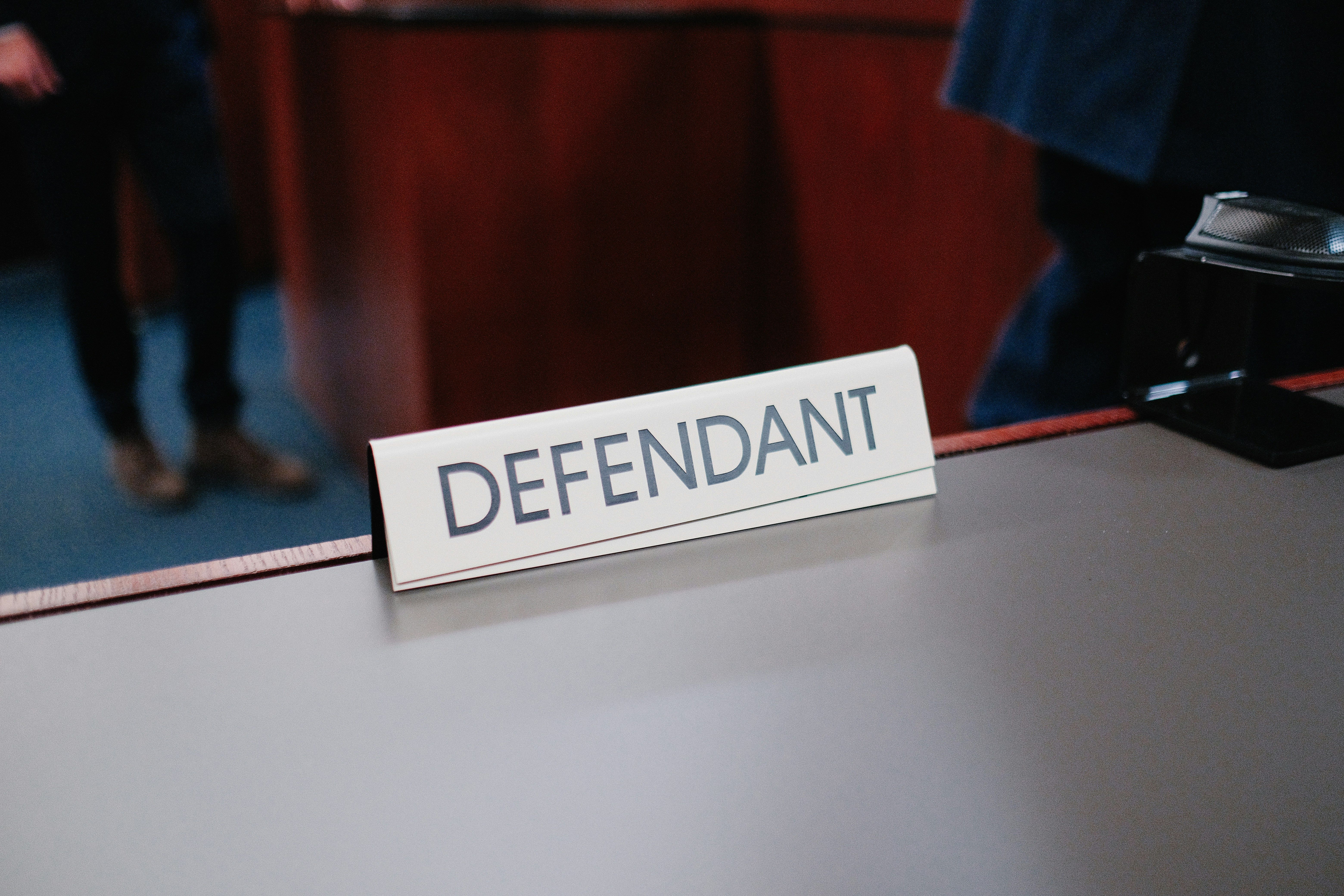 Defendant sign in court room by Wesley Tingey.