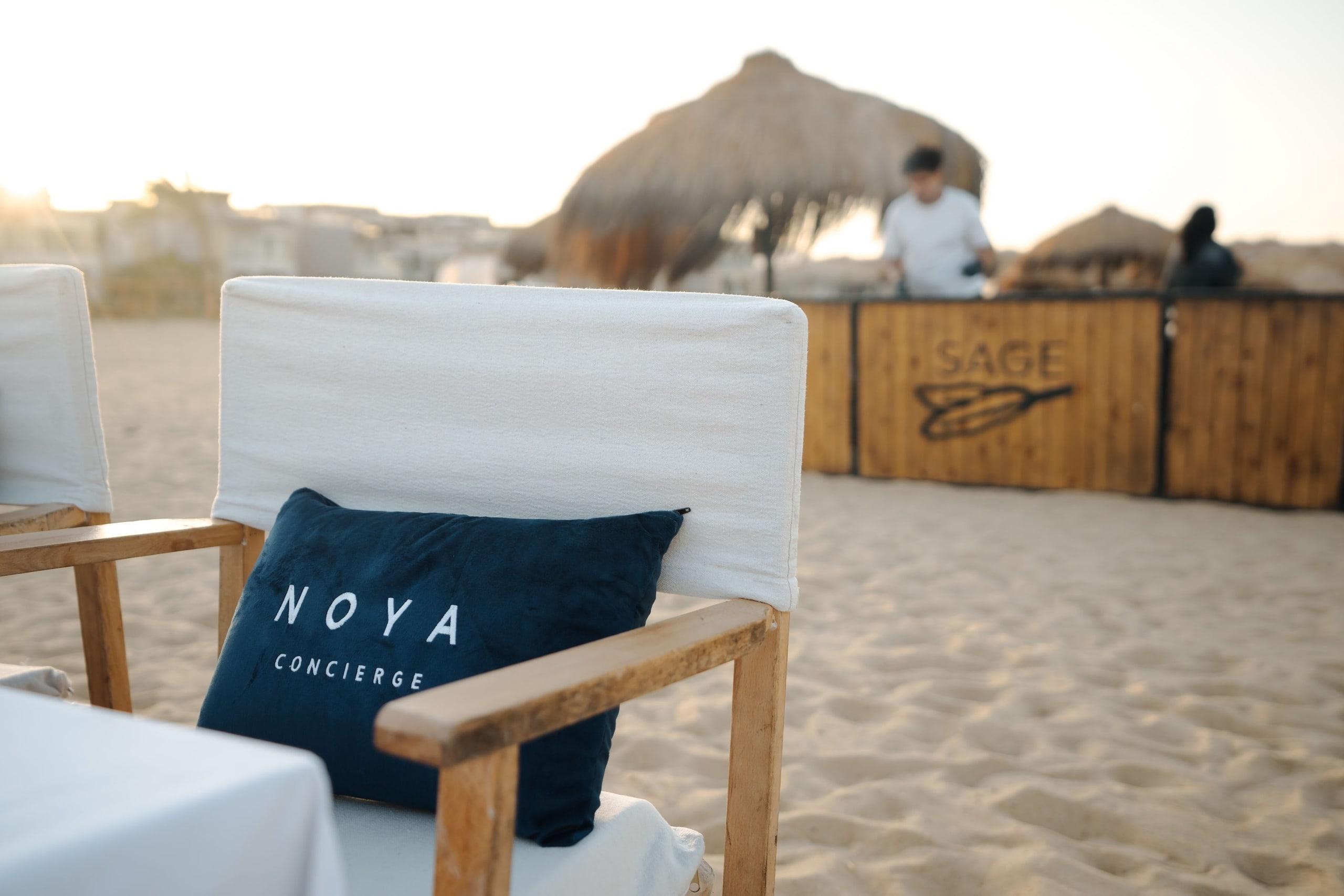 A beach dinner set with NOYA cushions on the chairs