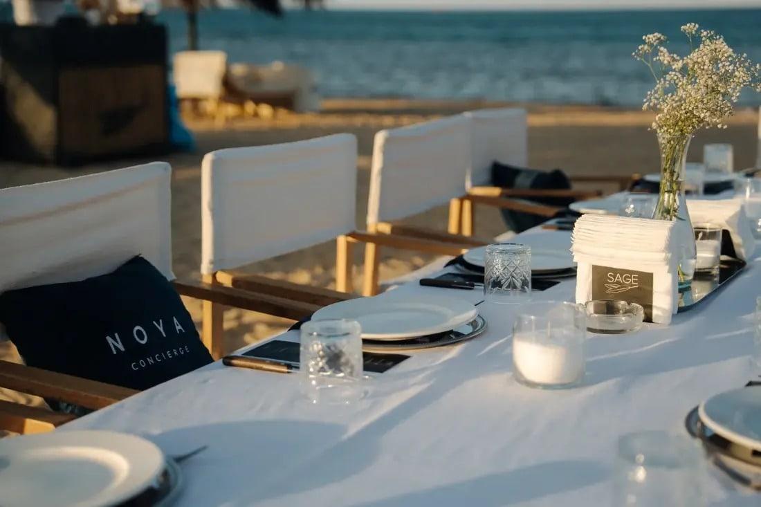 A NOYA table set for lunch beside the sea