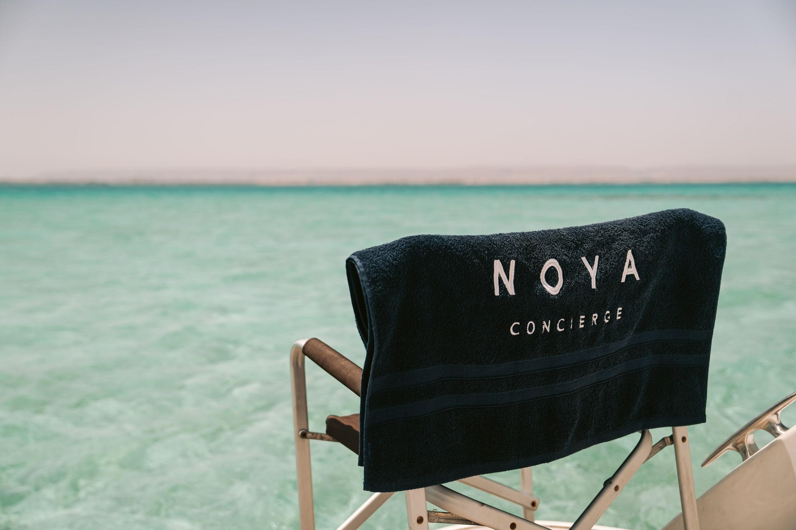 A NOYA director’s chair on a boat over clear water