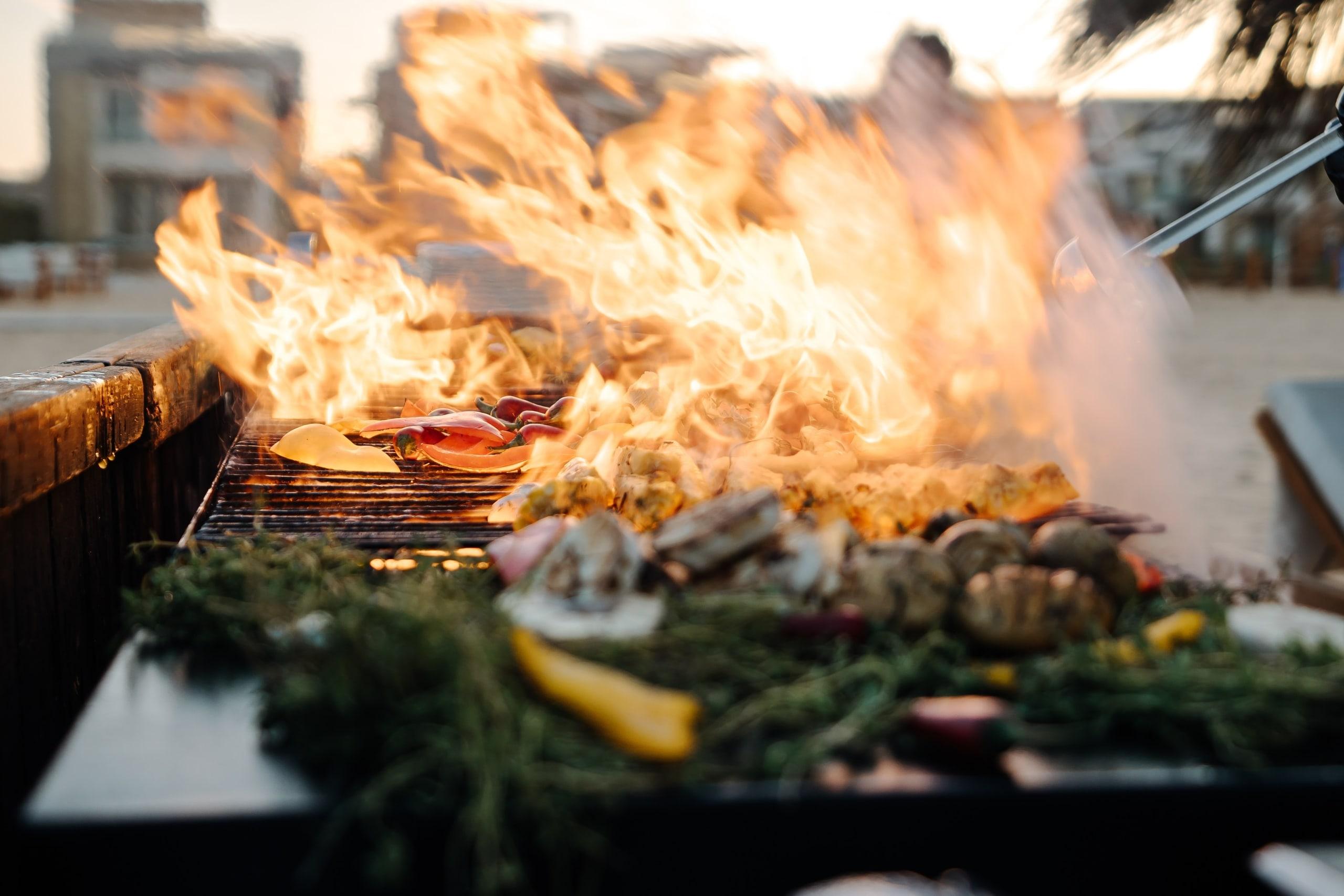 An open-fire grill at a beach dinner