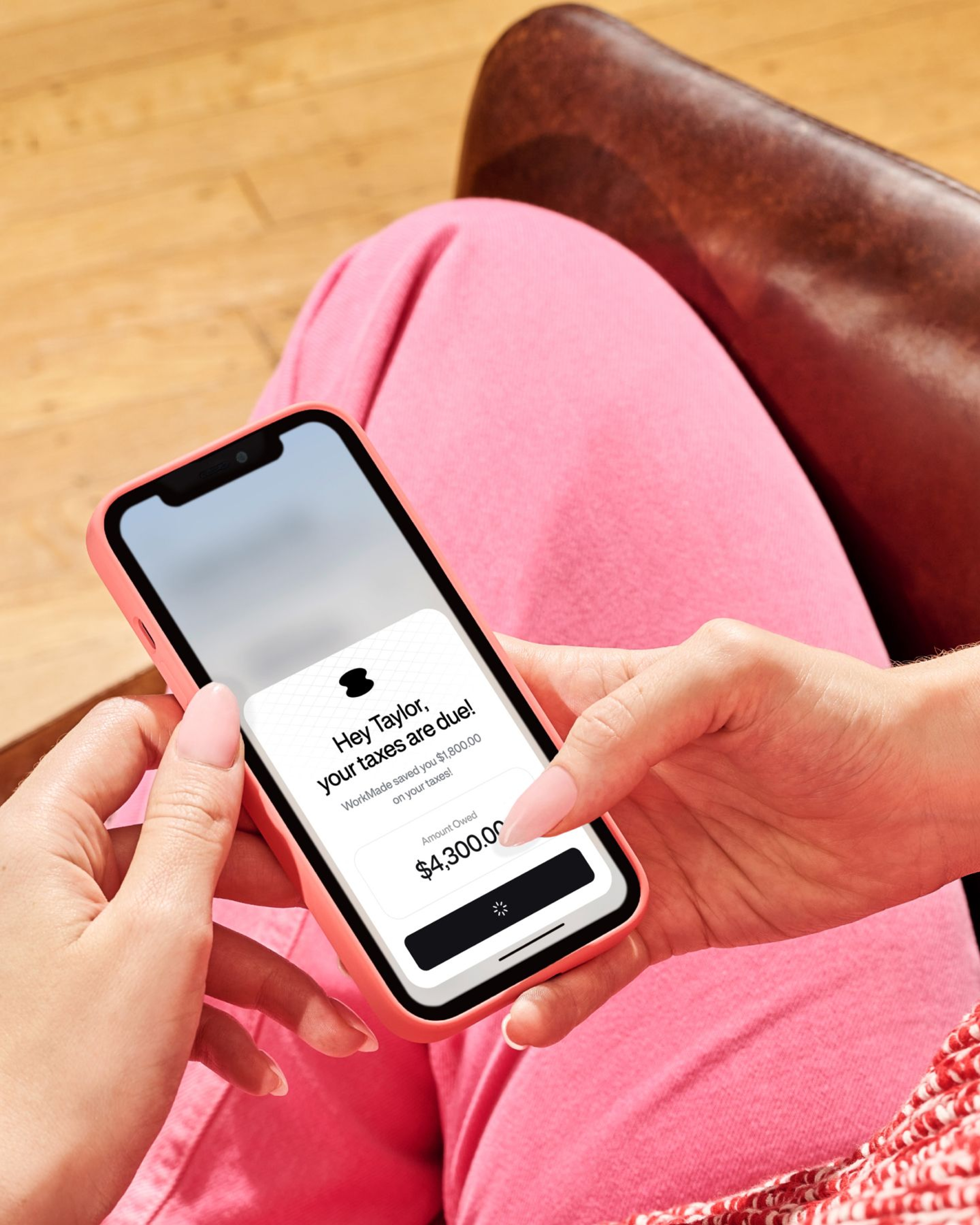 Person holding a phone with a tax notification from the WorkMade app