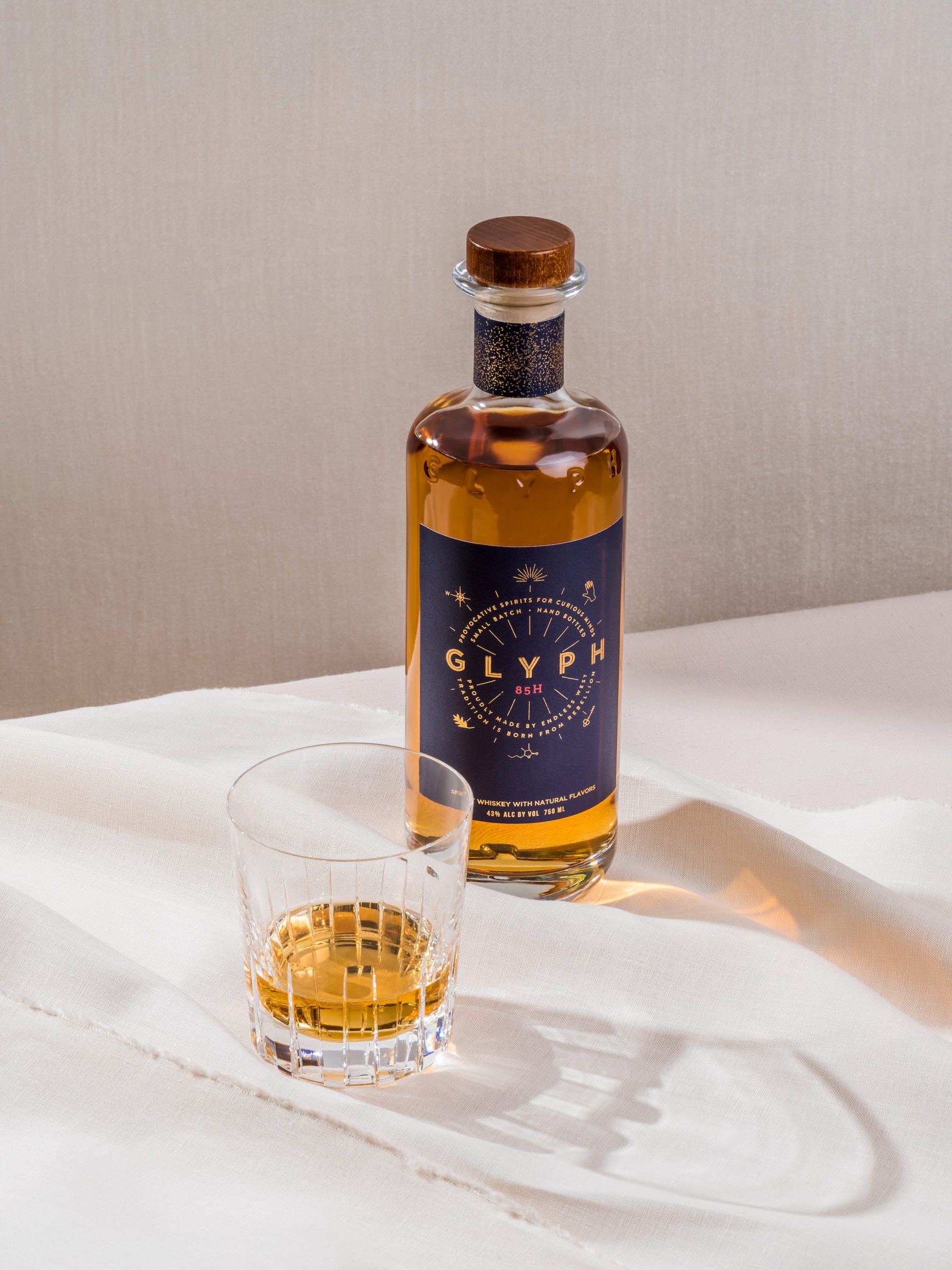 Cover for Endless West showing a bottle of Glyph and a tumbler with whisky