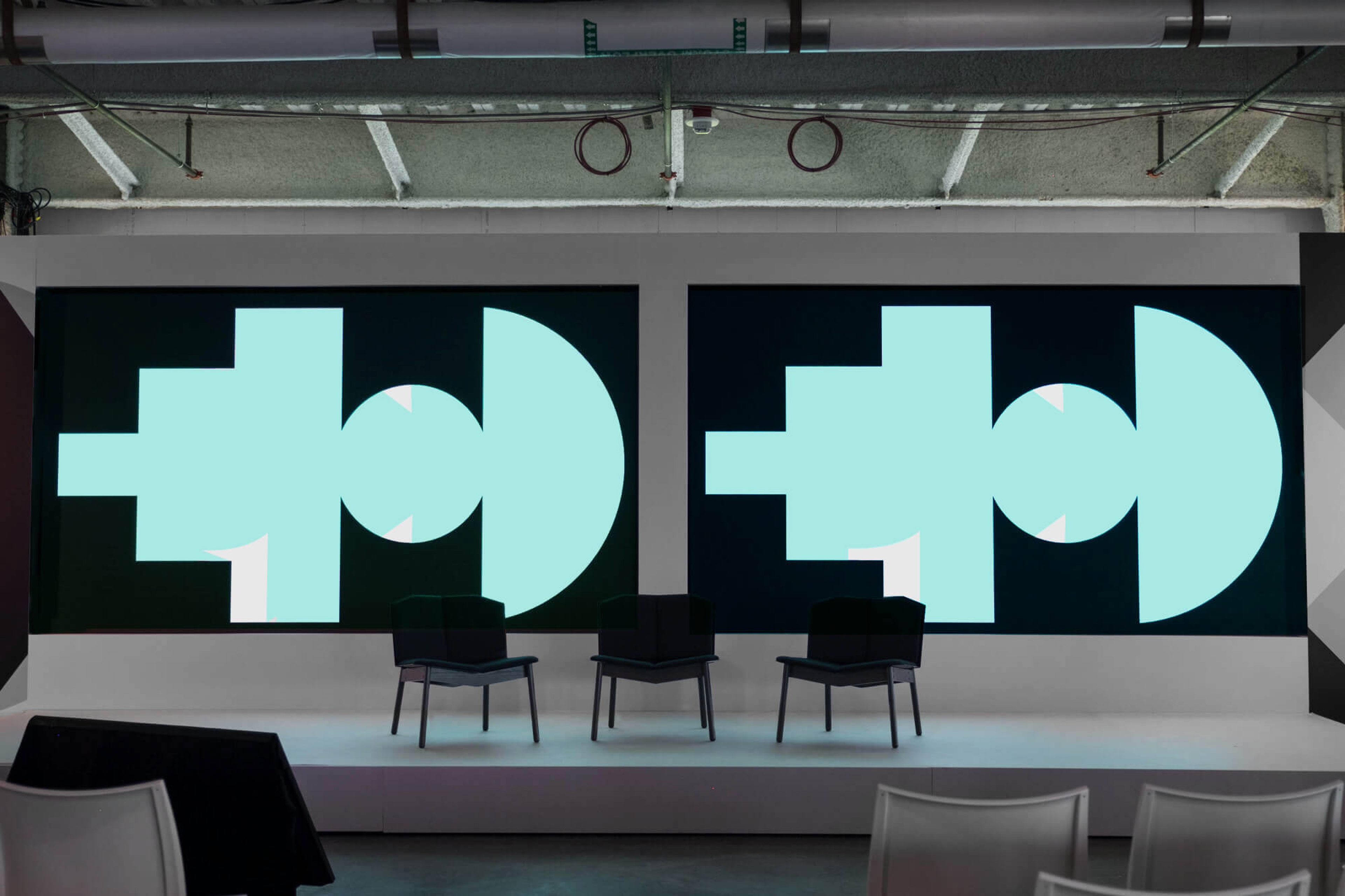 Photo of a stage with the Google SPAN conference screens on displays