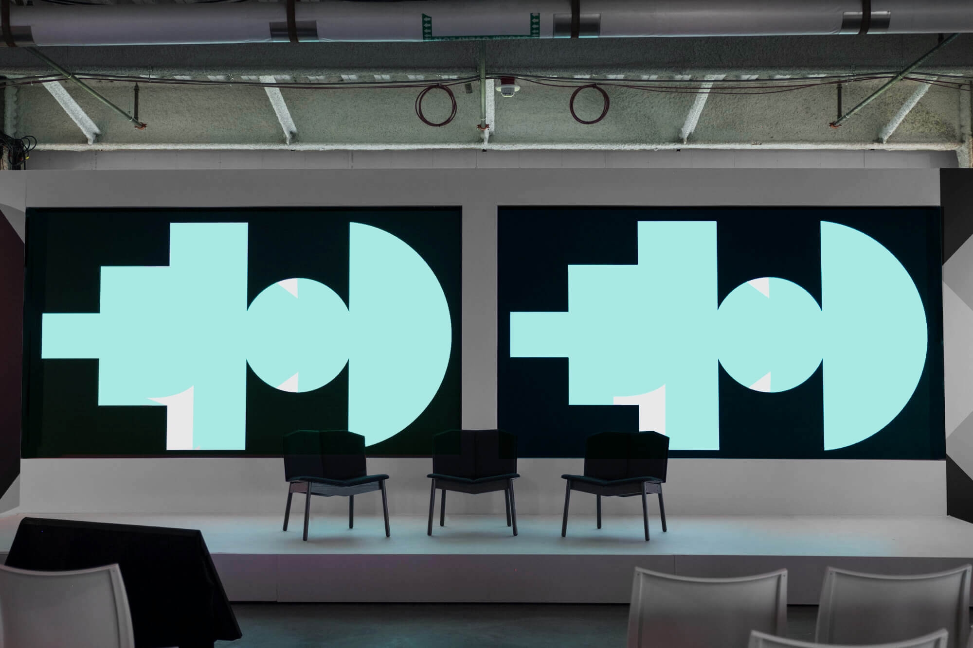 Photo of a stage with the Google SPAN conference screens on displays