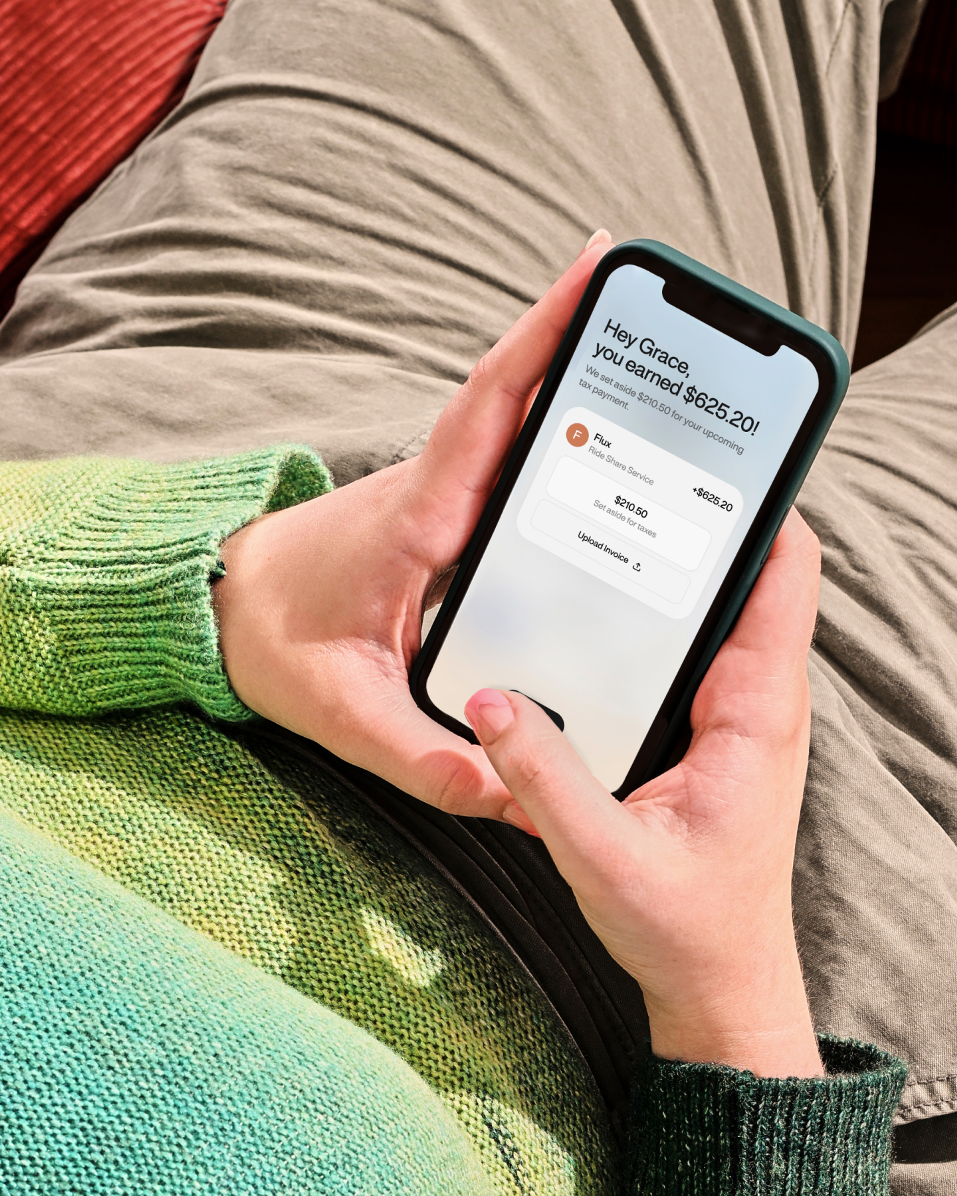 Person holding phone with an income notification from the WorkMade app