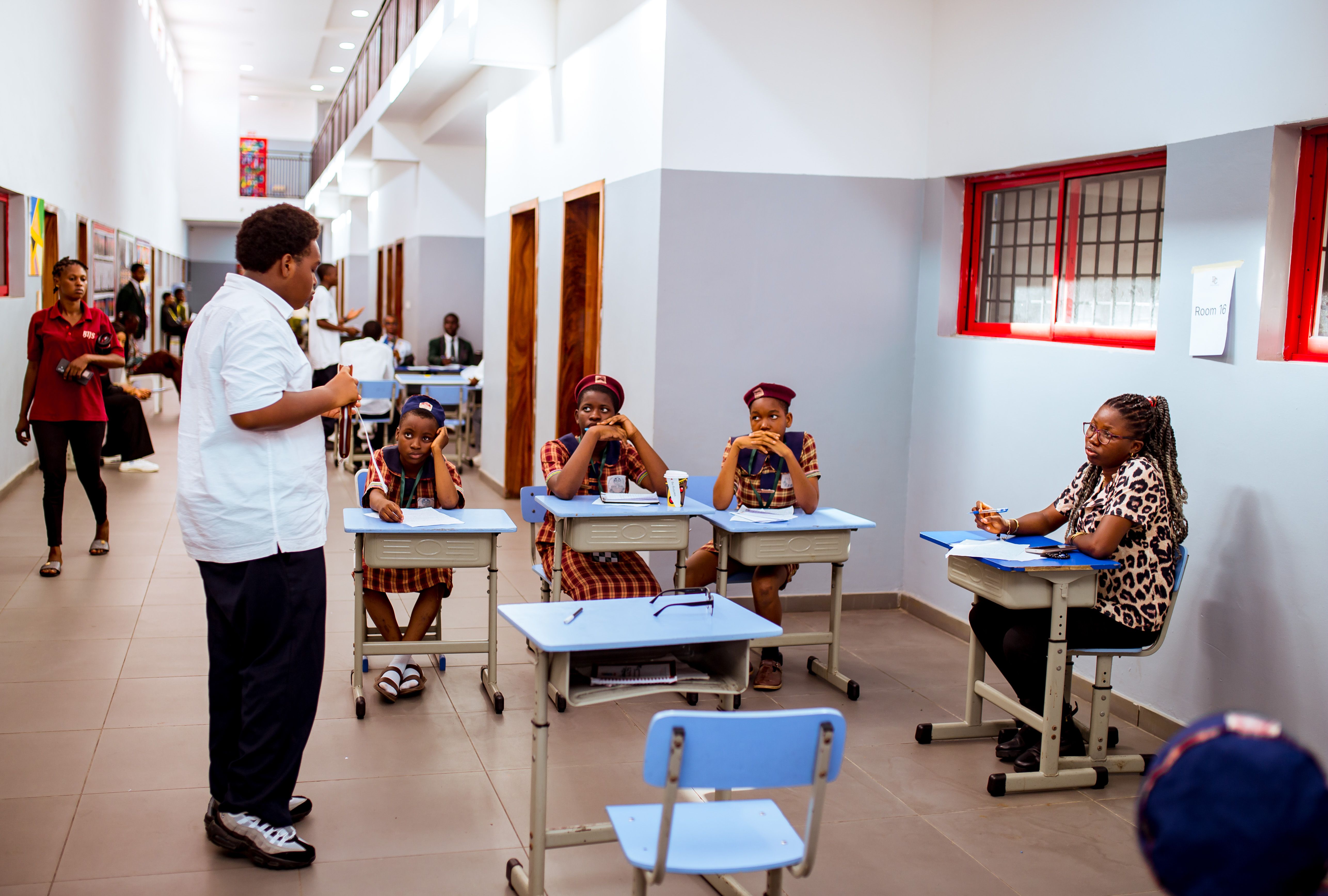 A coach working with students during a debate session