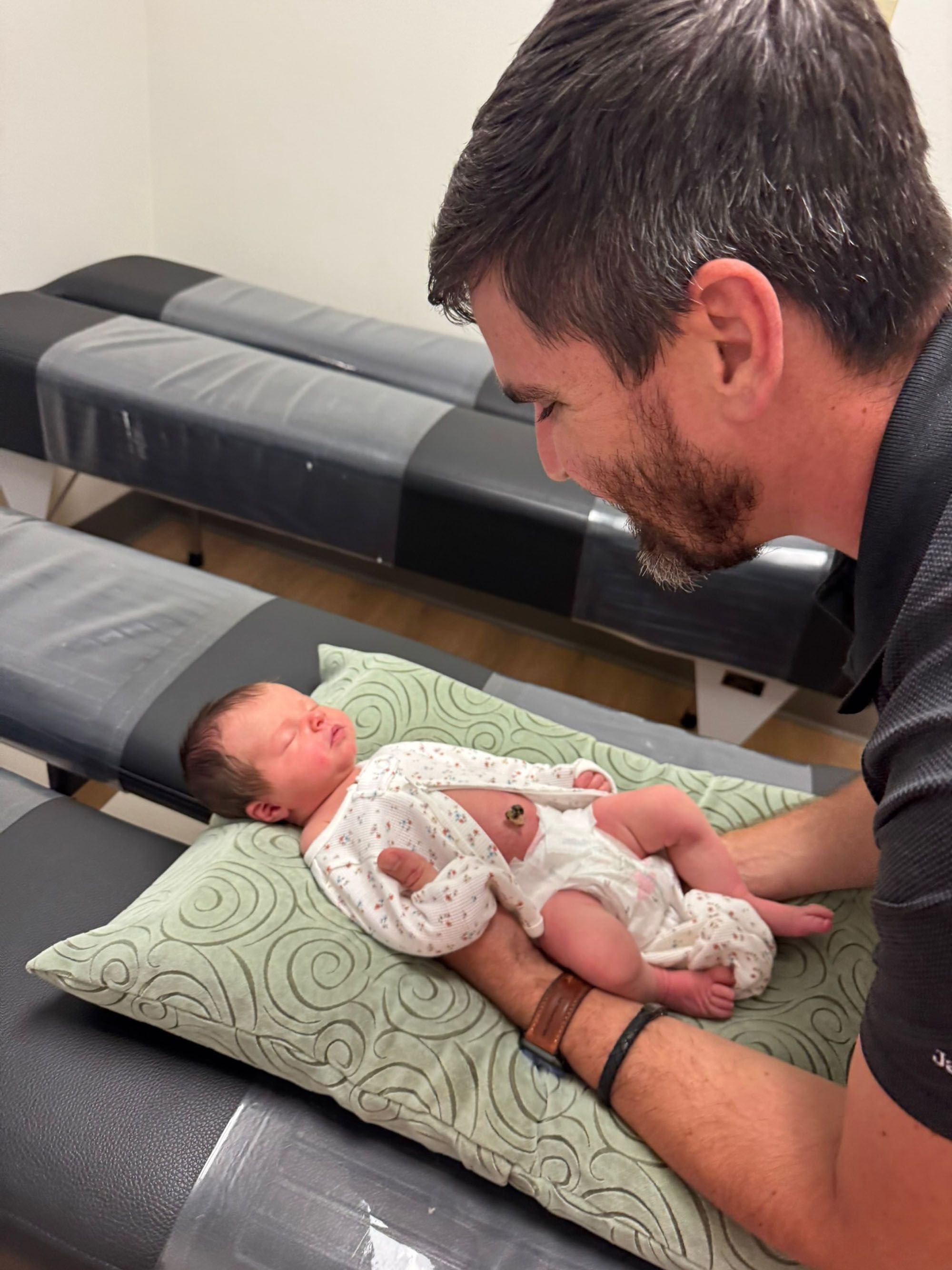 Dr. Logan Swaim adjusts a newborn with feather-light contact.