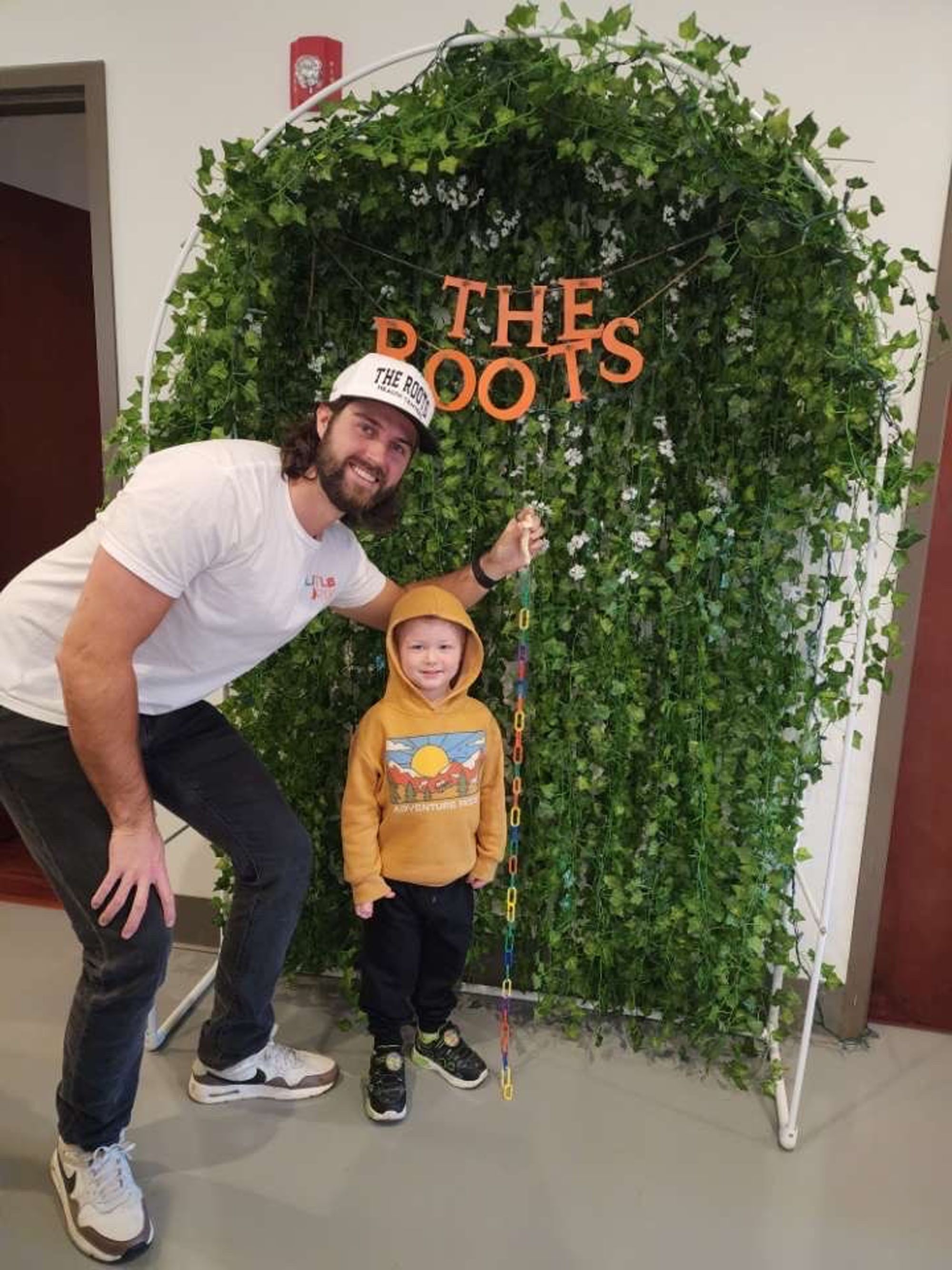 Dr. Logan with his son at The Roots' family day event.