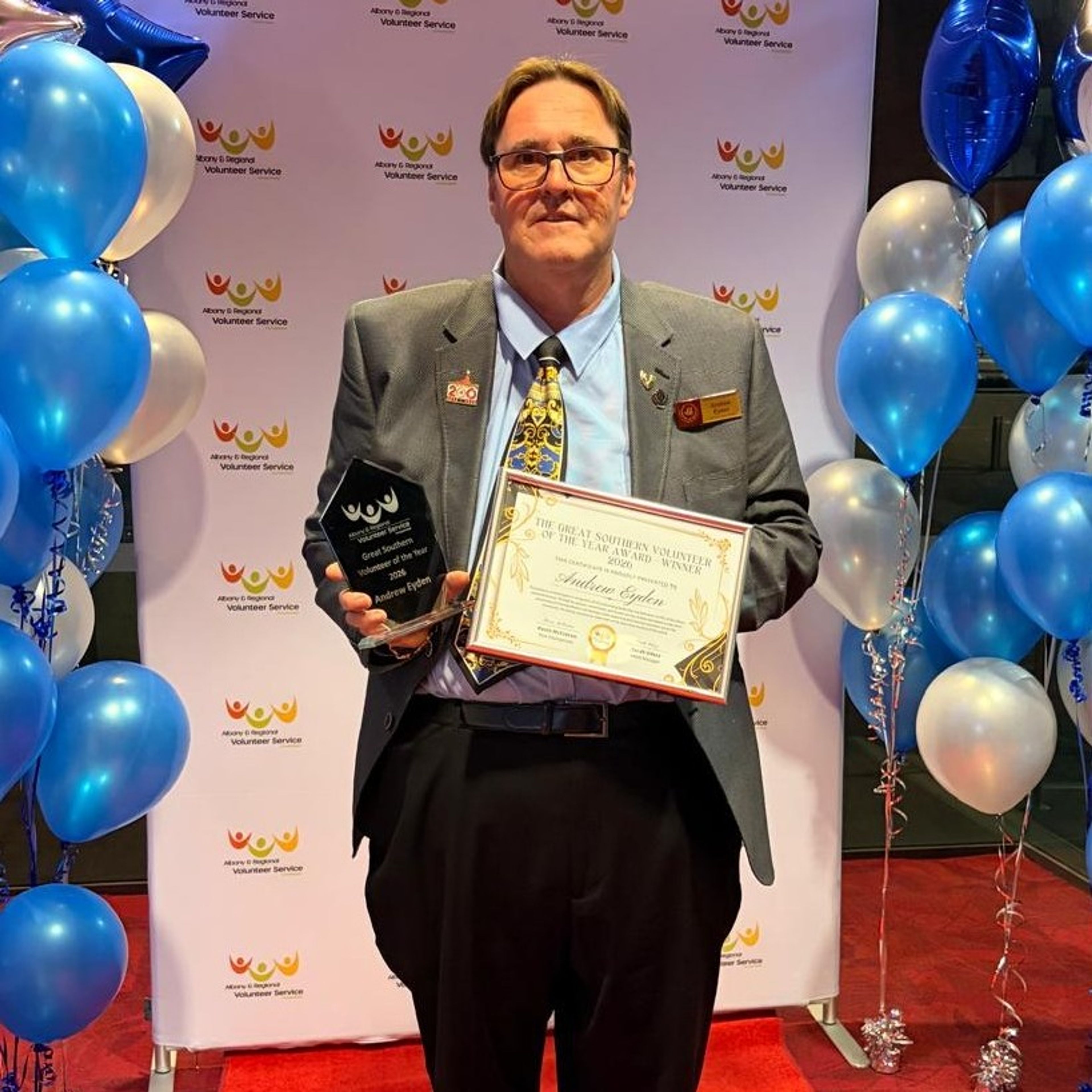 Andrew Eyden holding his award