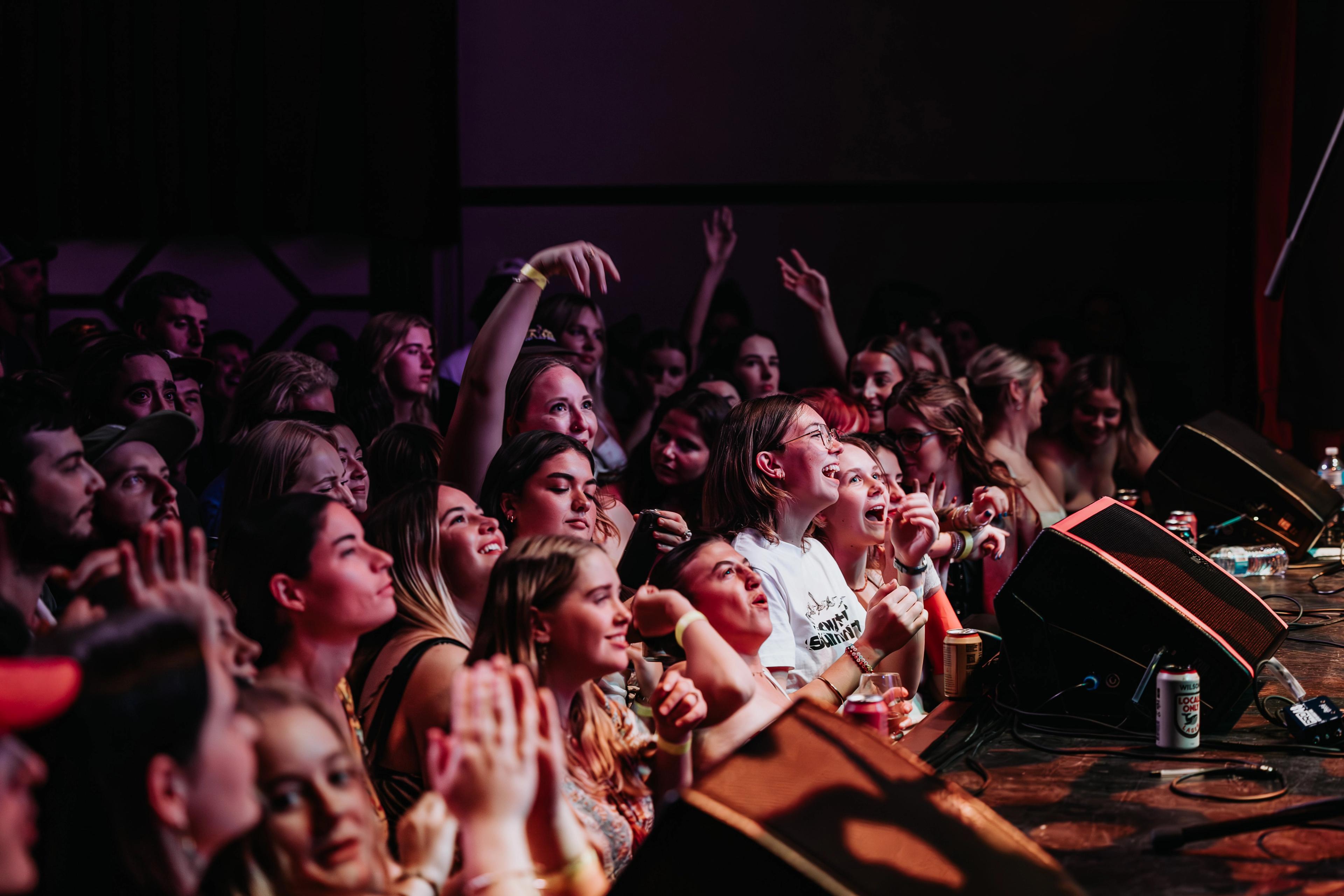 A packed crowd before a stage