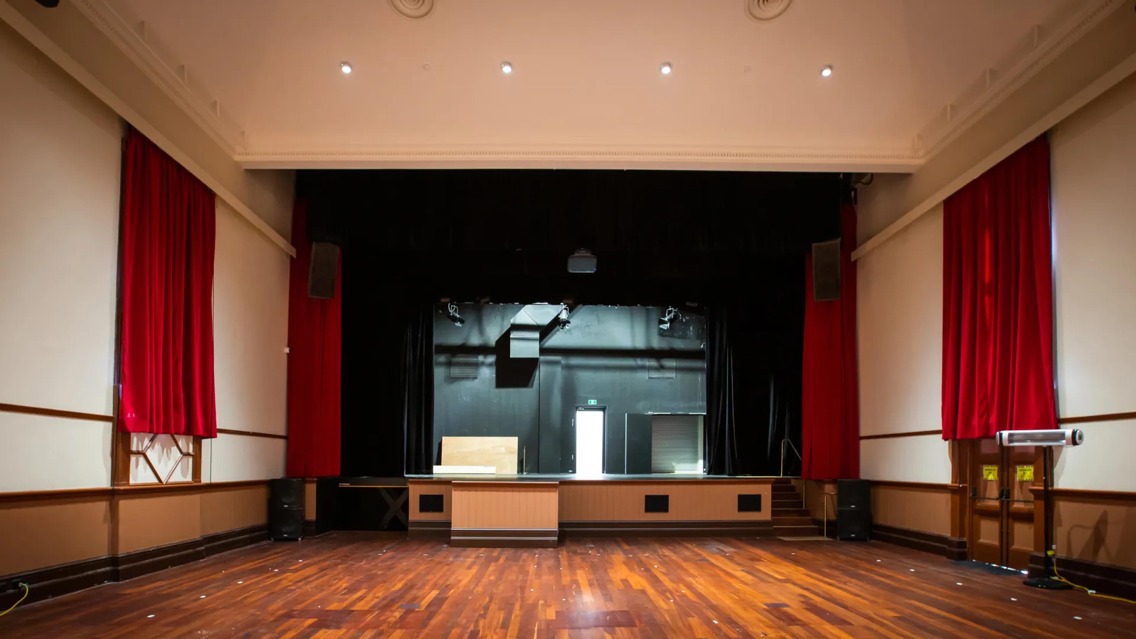 A photo of a theatre room and stage.