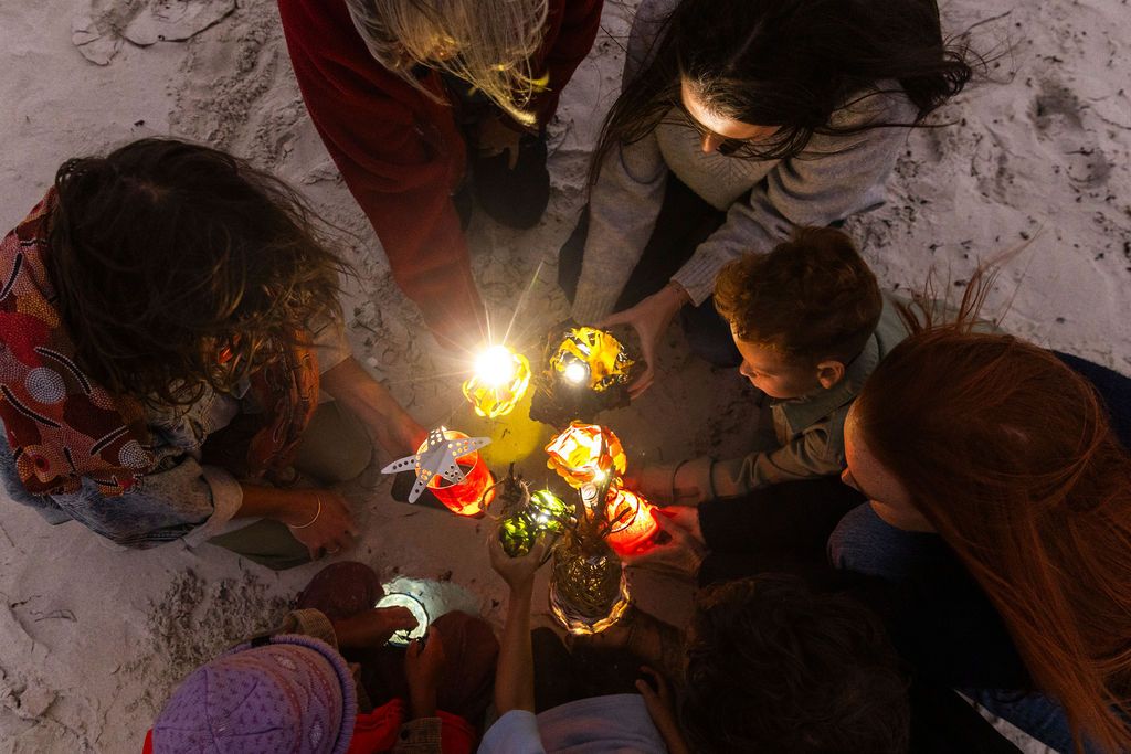 Lanterns illuminating a cluster of people
