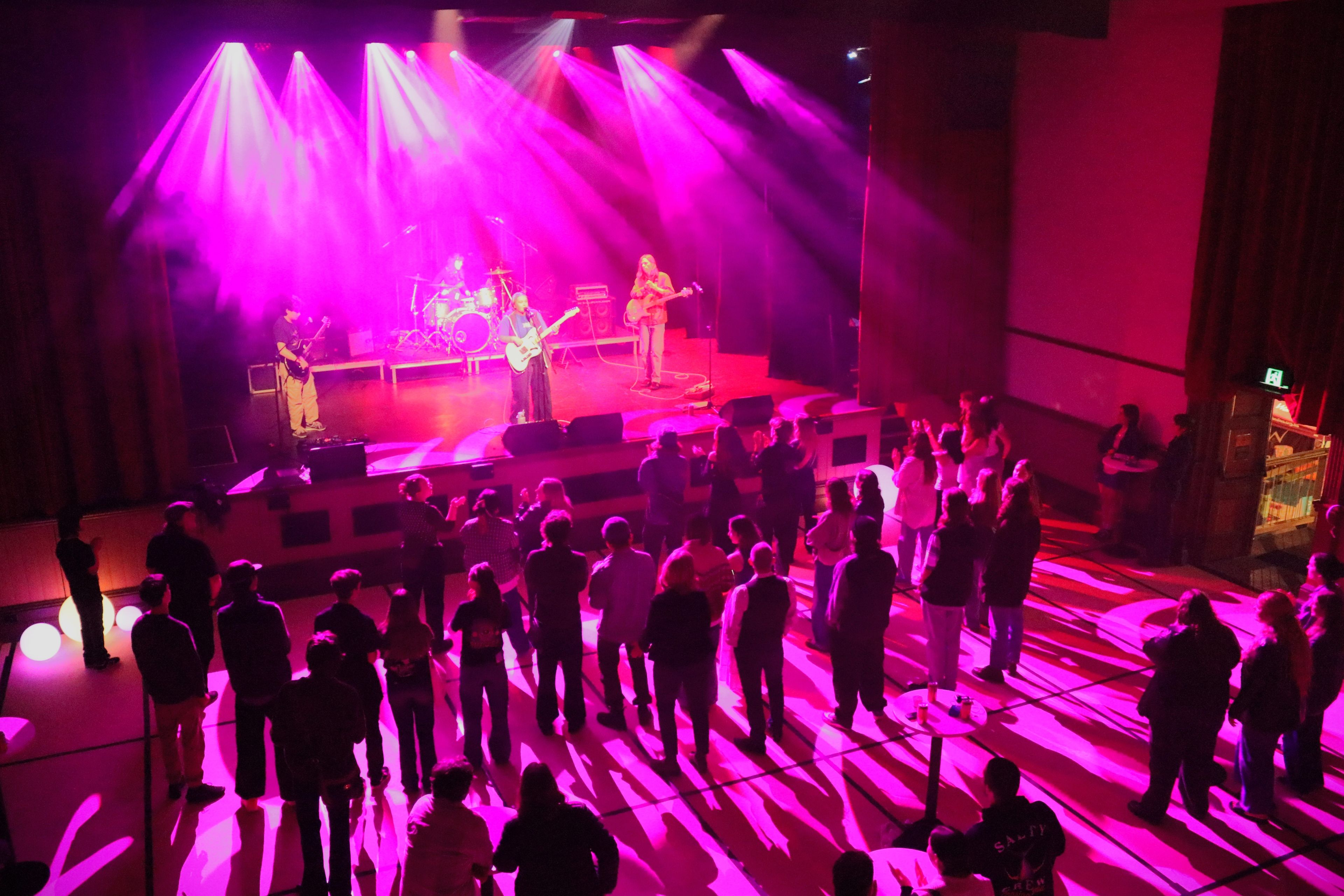 Crowd of people watching a live band.
