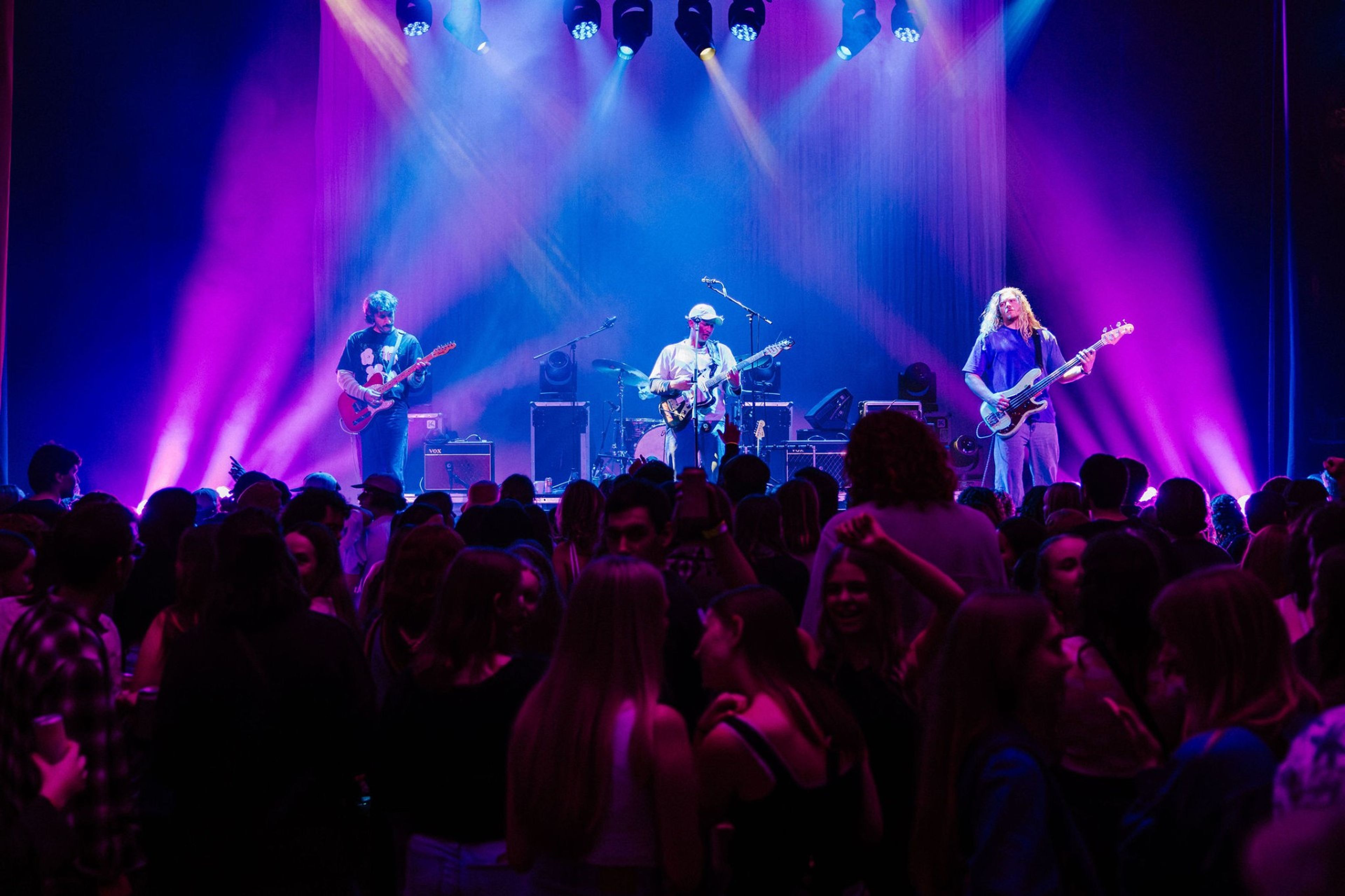 Crowd of people watching a live band.