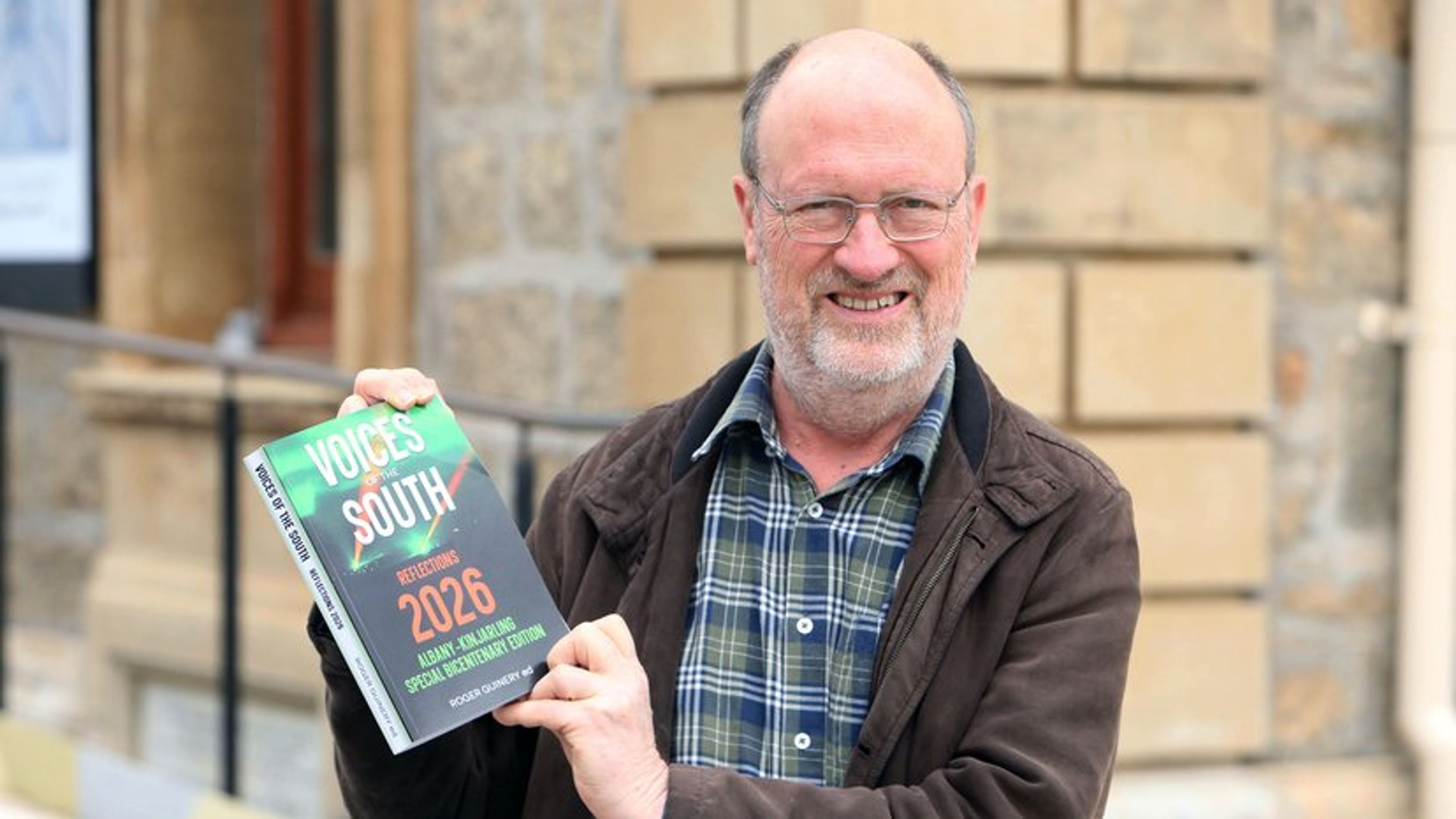 Roger Guinery holding Voices of the South: Reflections 2026 outside the Albany Town Hall