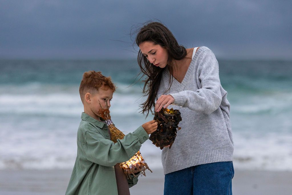 Young boy and young woman comparing lanterns