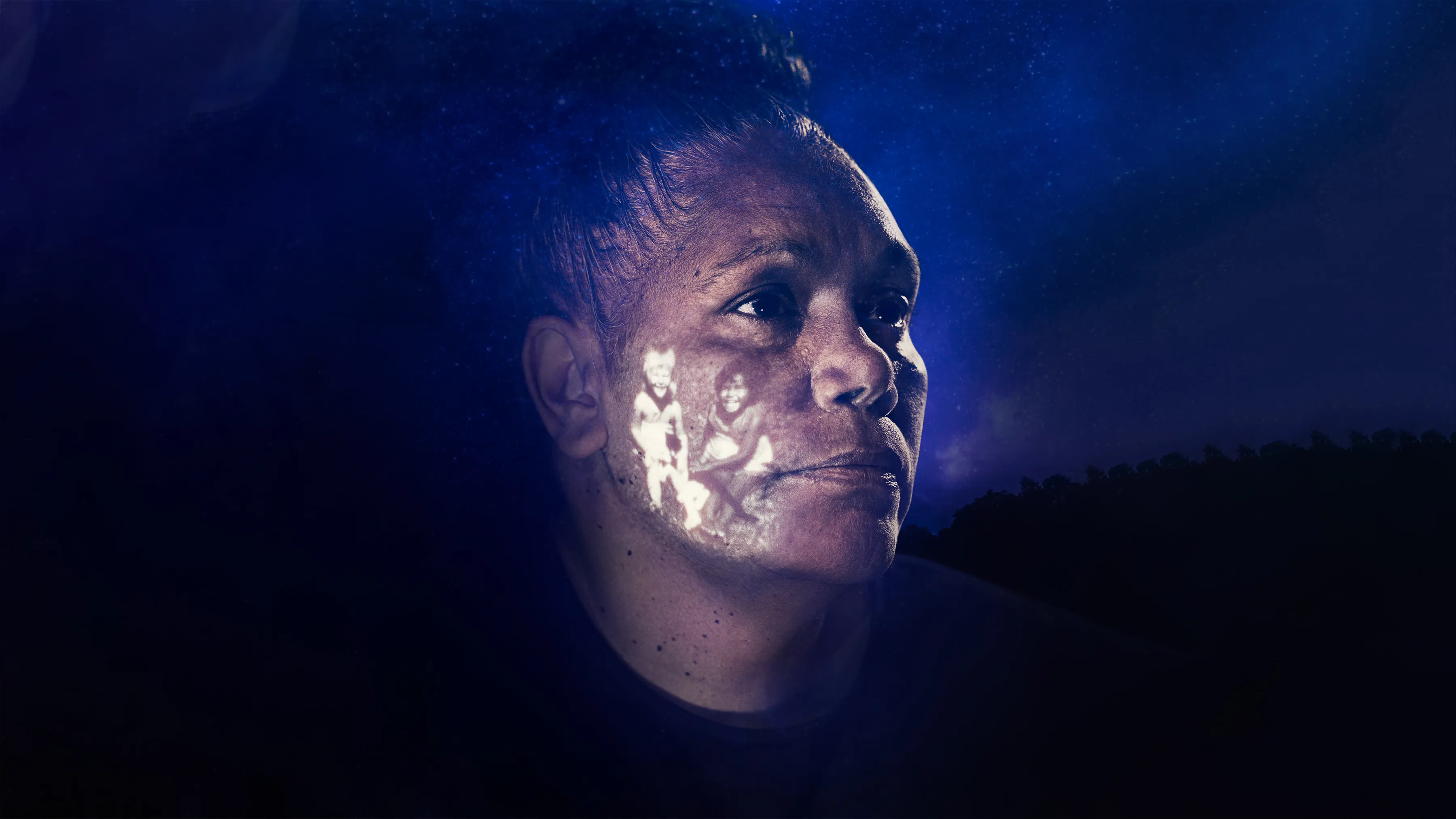 Close-up image of Brenda, with a photograph of her childhood projected onto her face