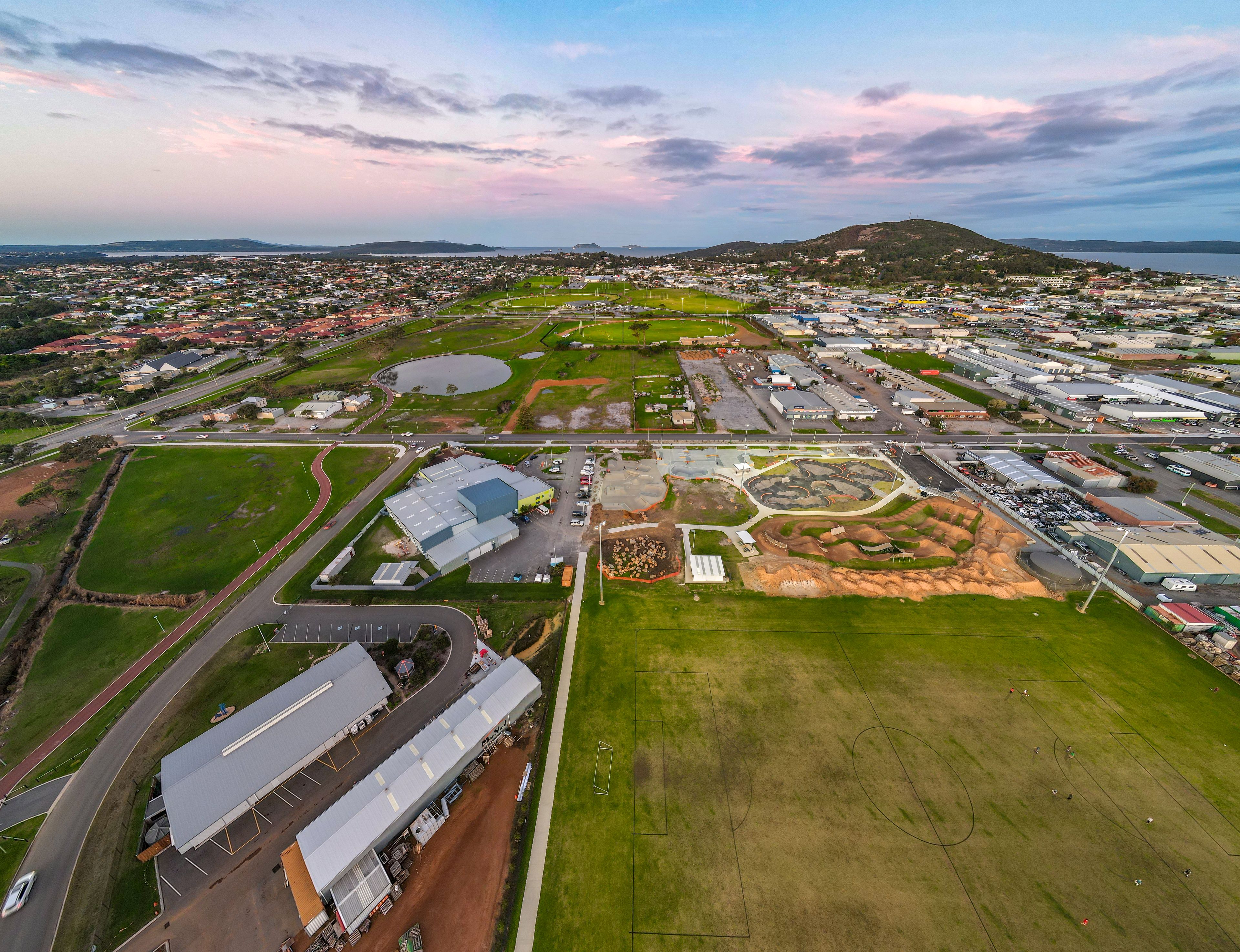 An aerial image of the Centennial Park Sporting Precinct, stretching towards the ocean in the distance.