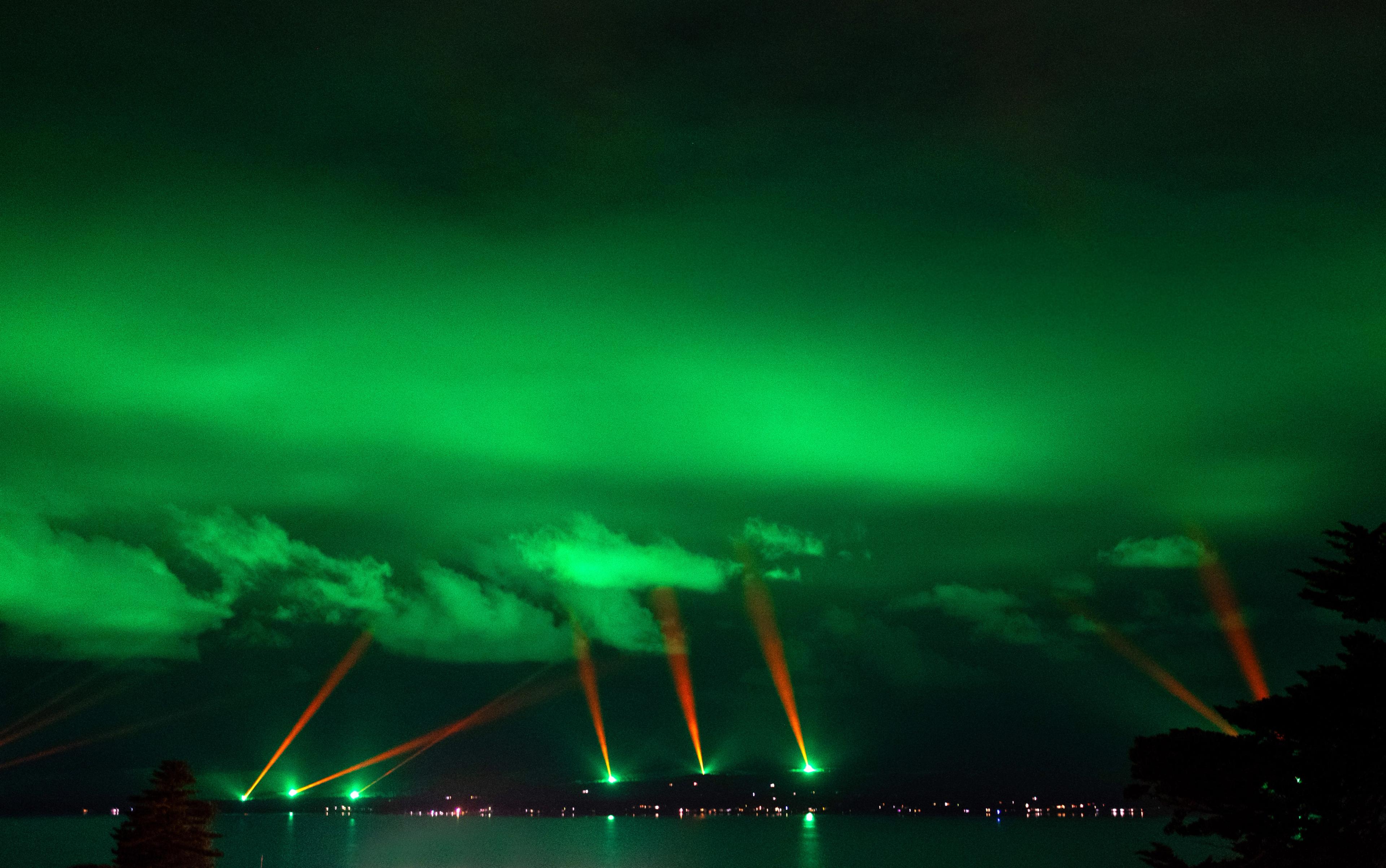 A photo of Albany's coastline at night time with the lights in full display above.