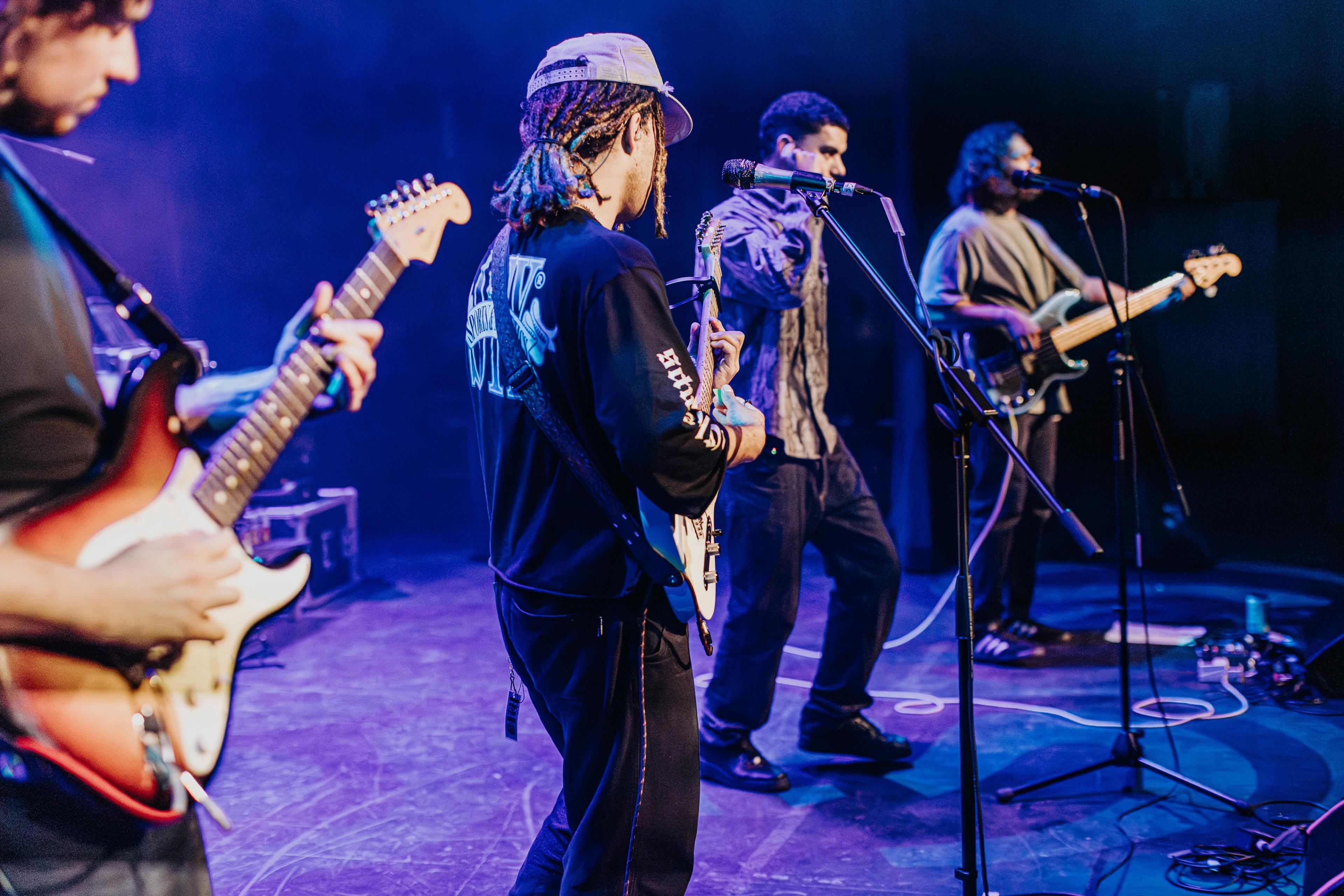 Performers on a purple stage