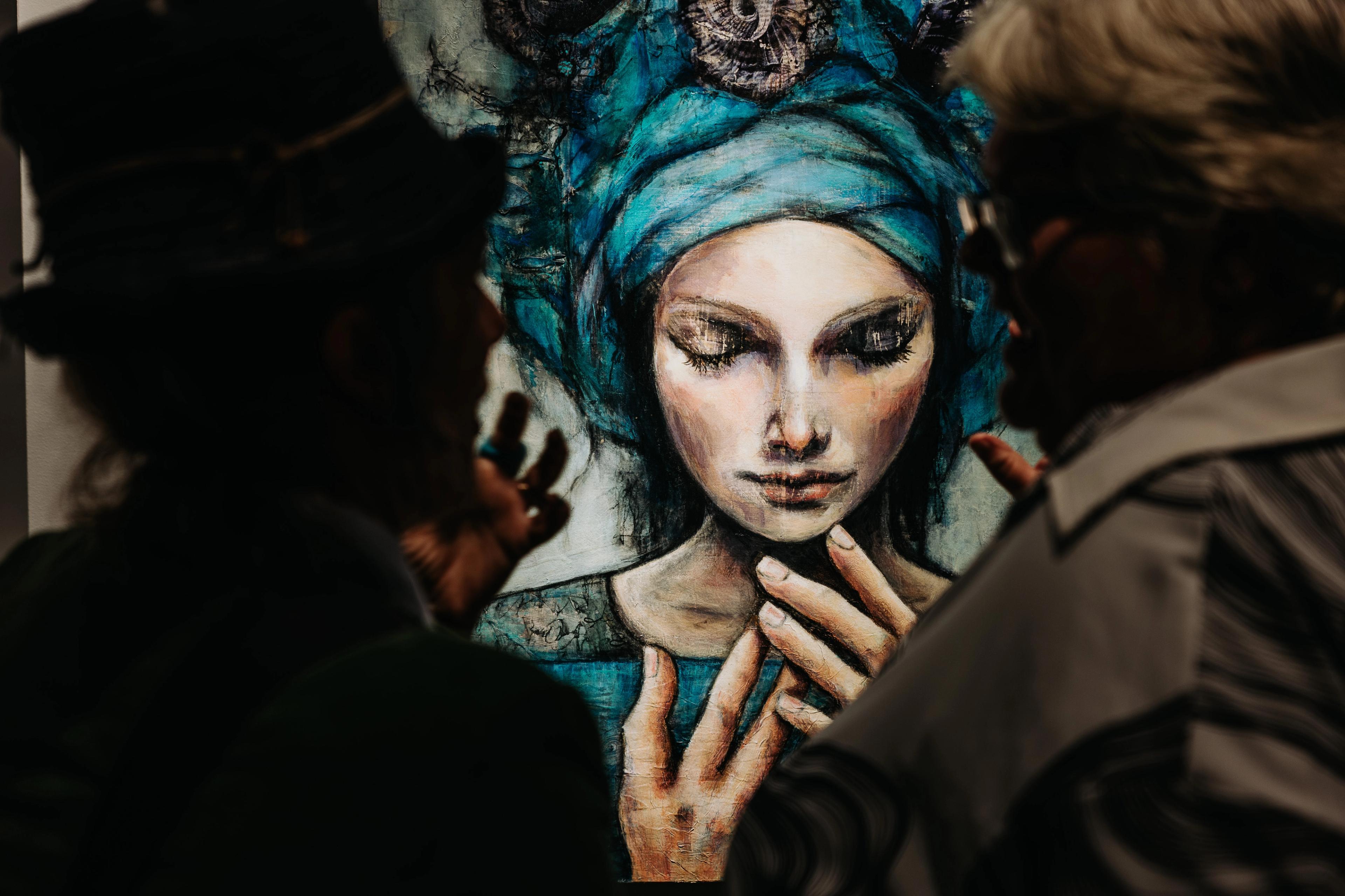 People looking at Tracey Margetts painting, Amity and the Alchemy of Water