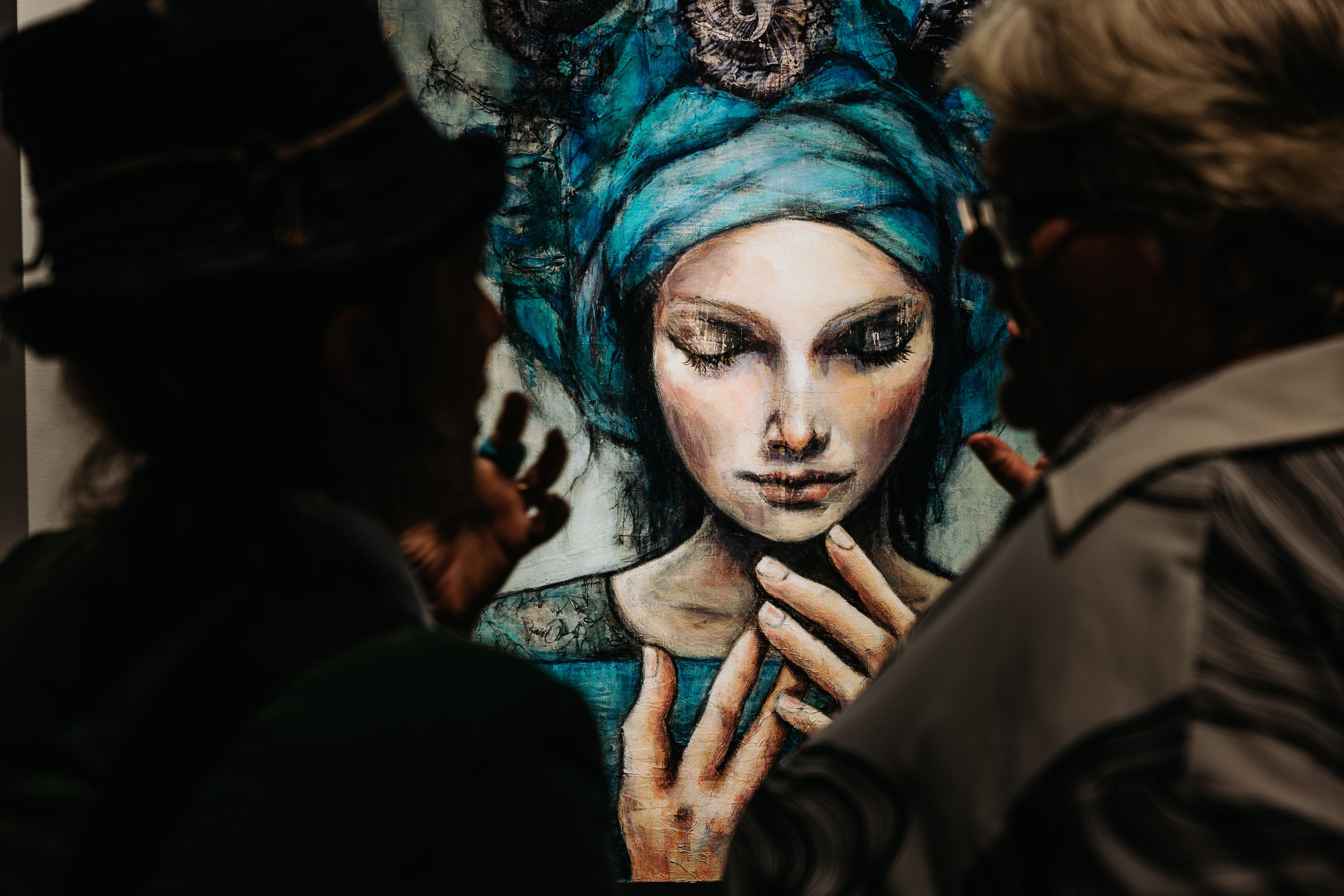 People looking at Tracey Margetts painting, Amity and the Alchemy of Water