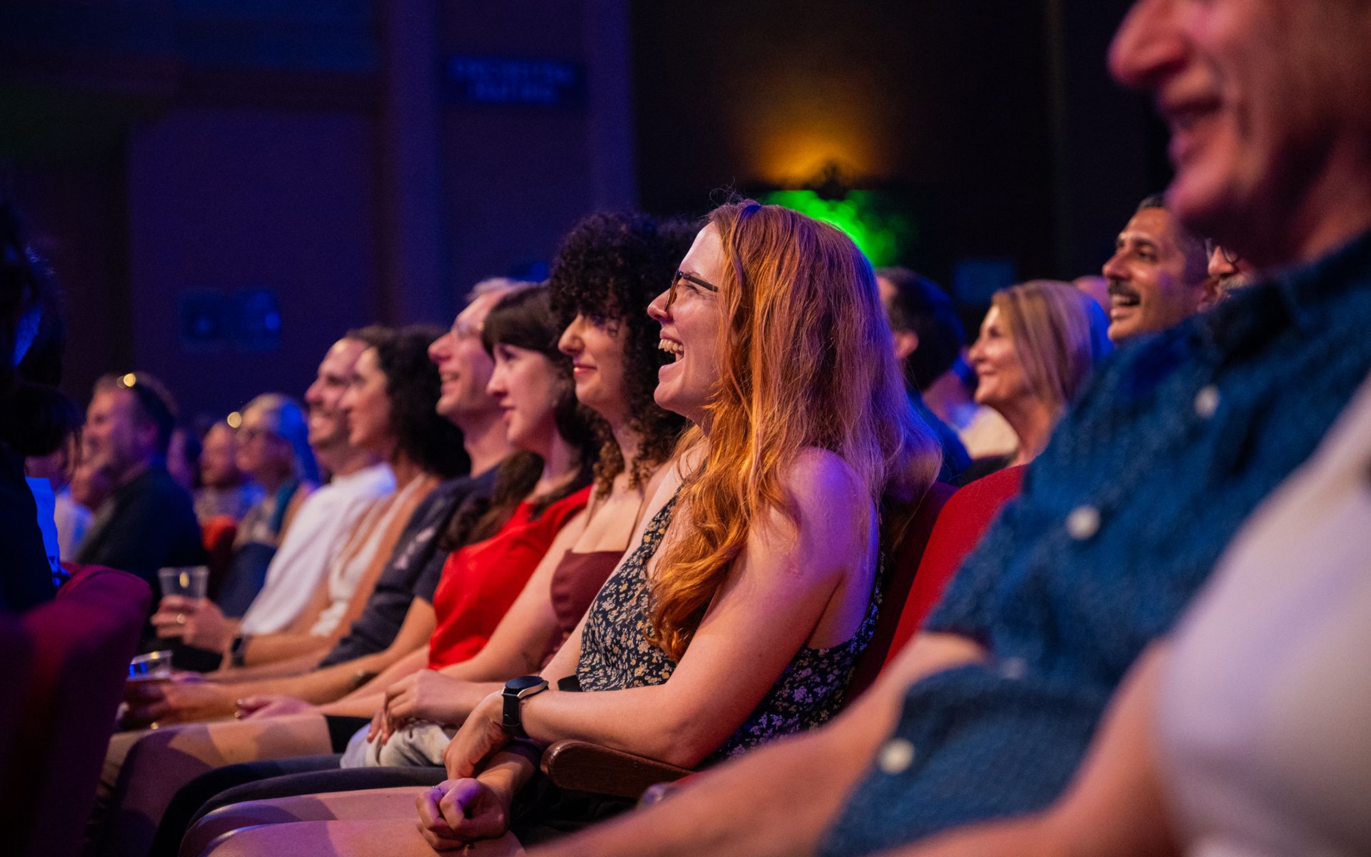 Audience members laughing