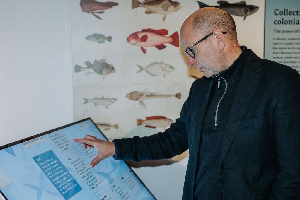 Man engaging with exhibition screens
