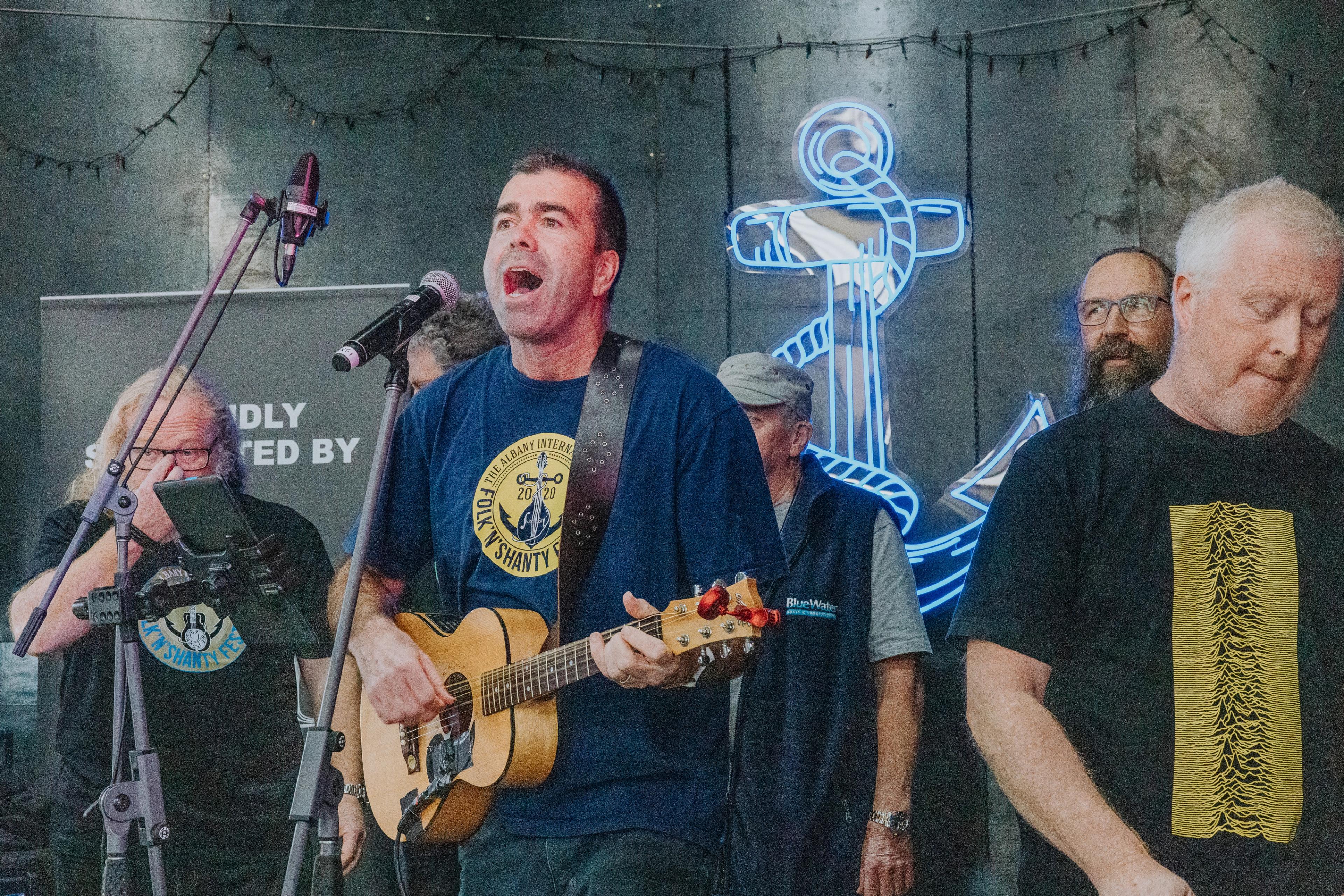 Shanty performers heartily perform on stage