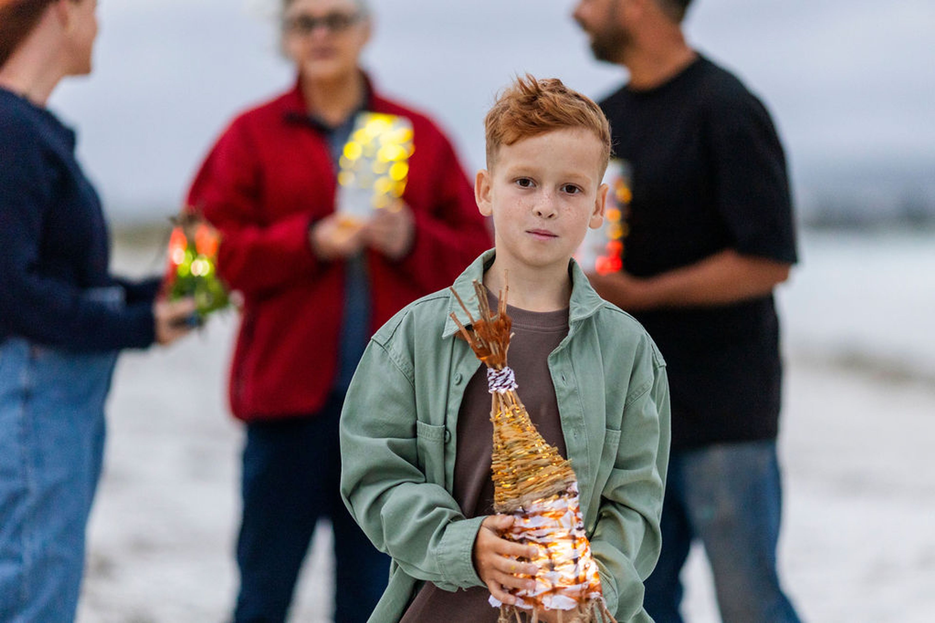 A photo of young boy holding a handmade lantern