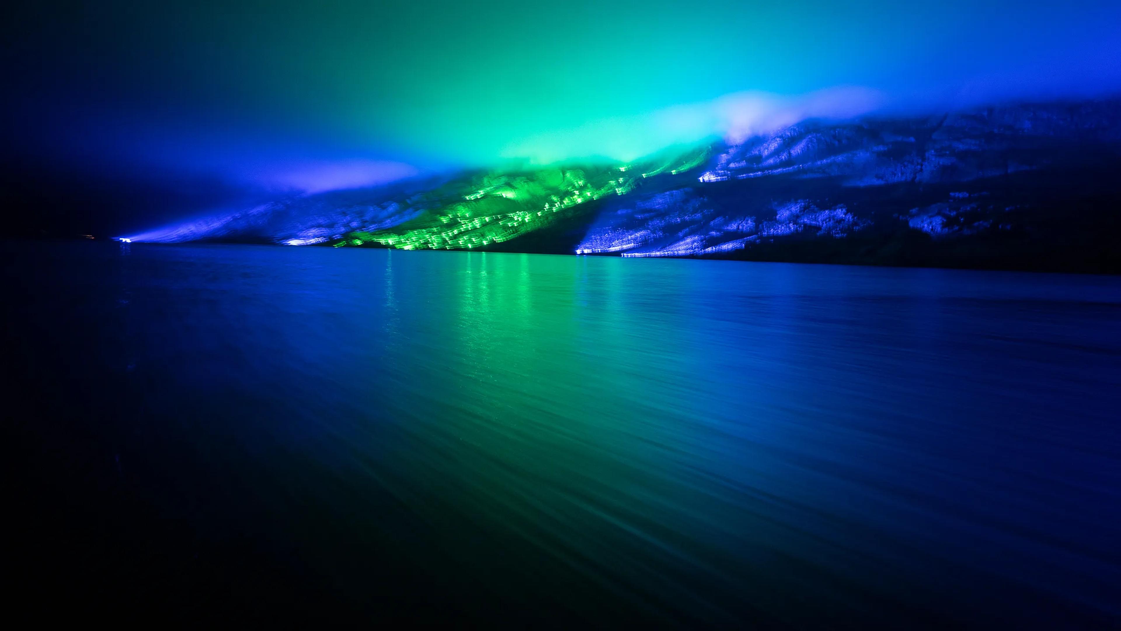 A photo of Albany at night time with the southern lights in full display above.