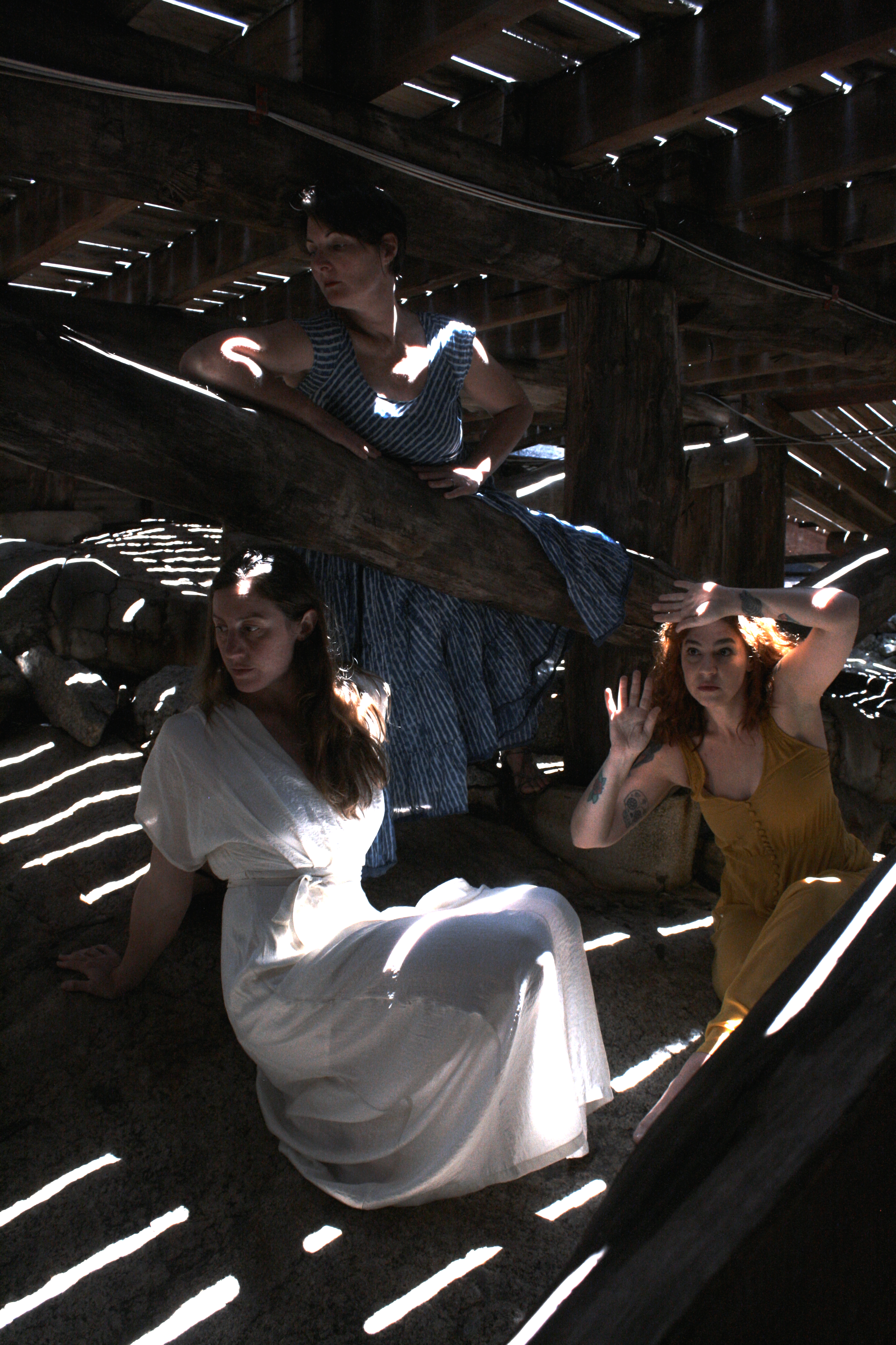 A group of young people in the dim light under decking