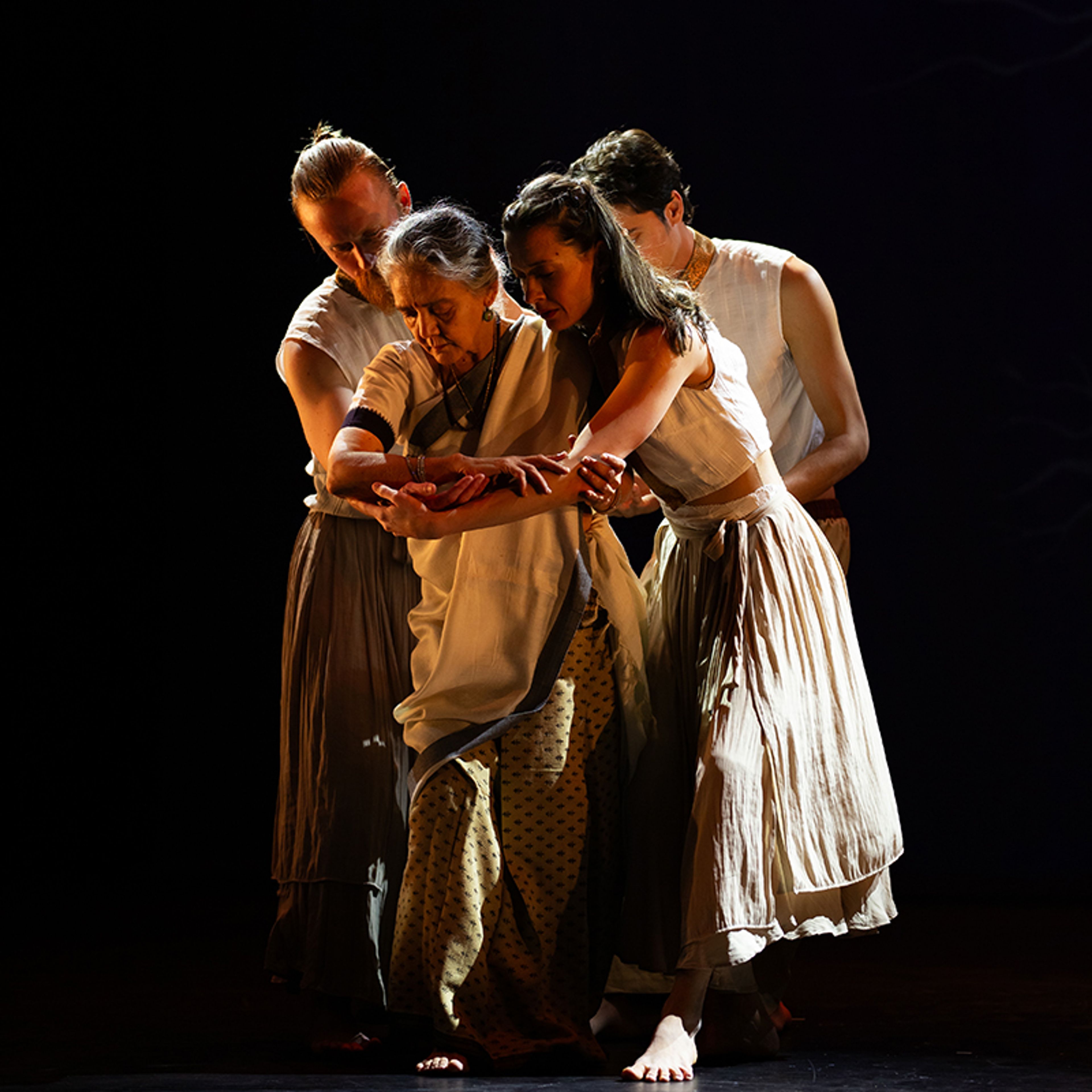 Performers before a dark background