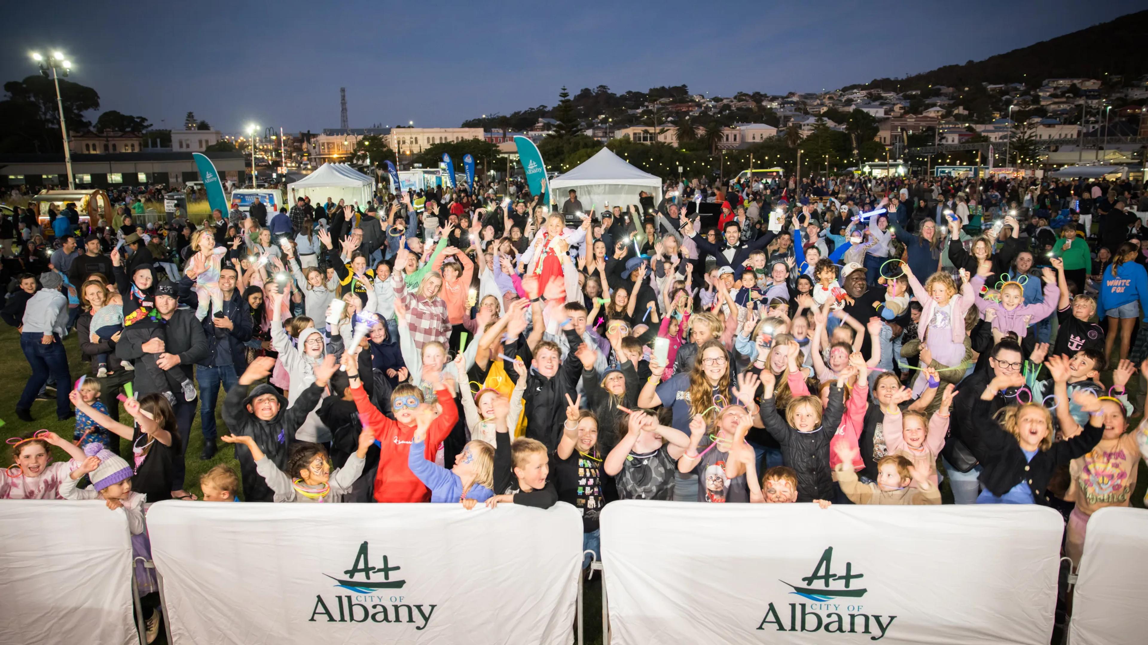 A photo of a group of people celebrating at a festival.