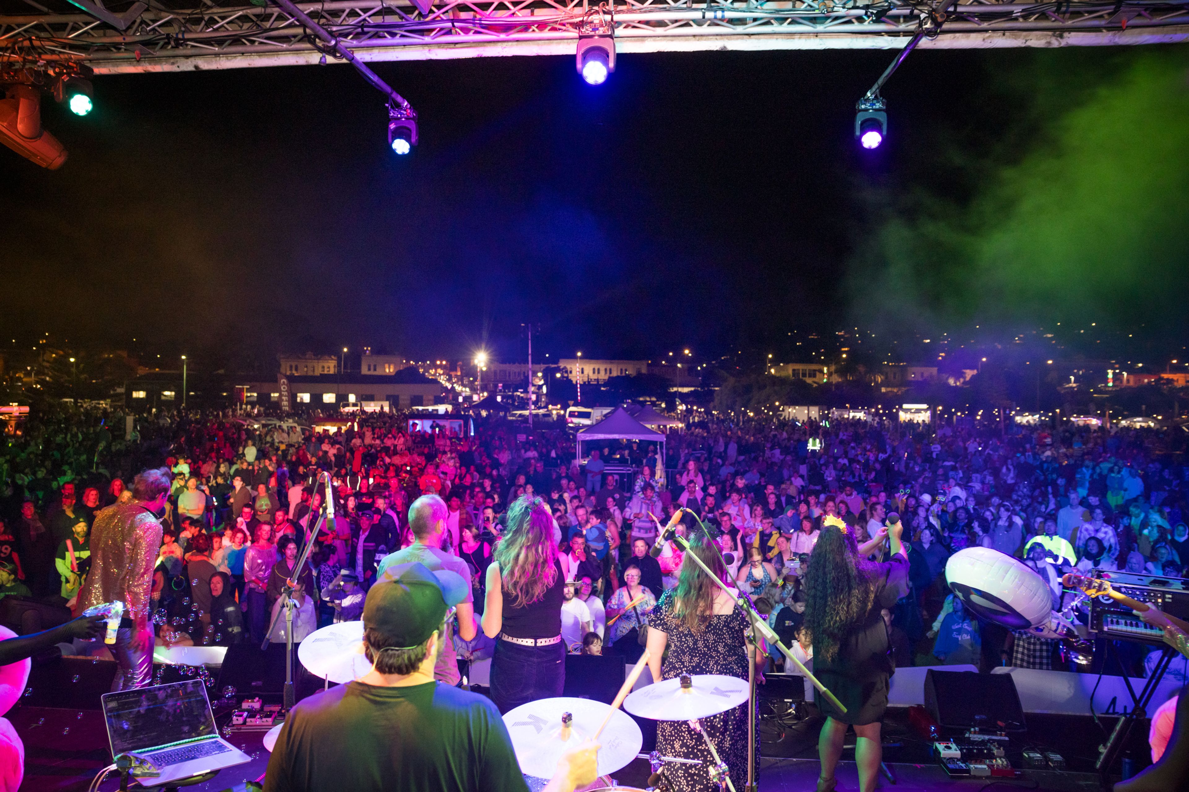 Band on stage performing to large crowd