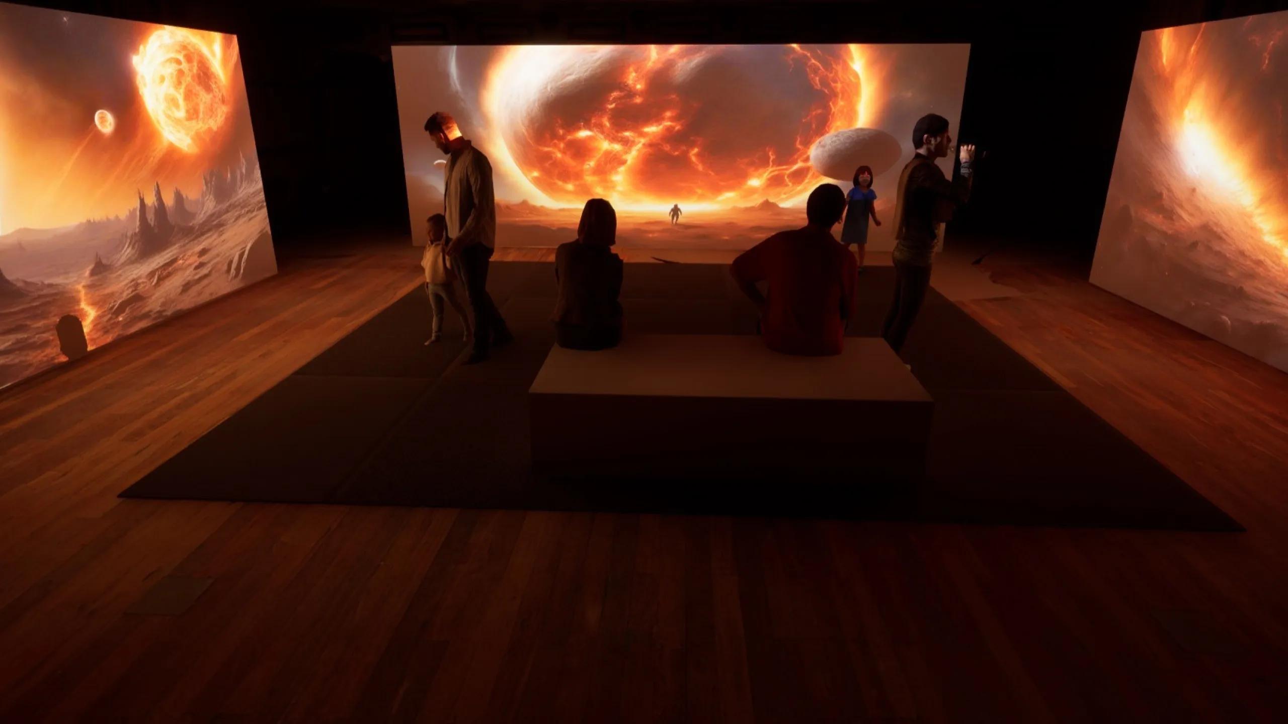 A photo of some people standing in front of 3 screens with planetary mockups on them.