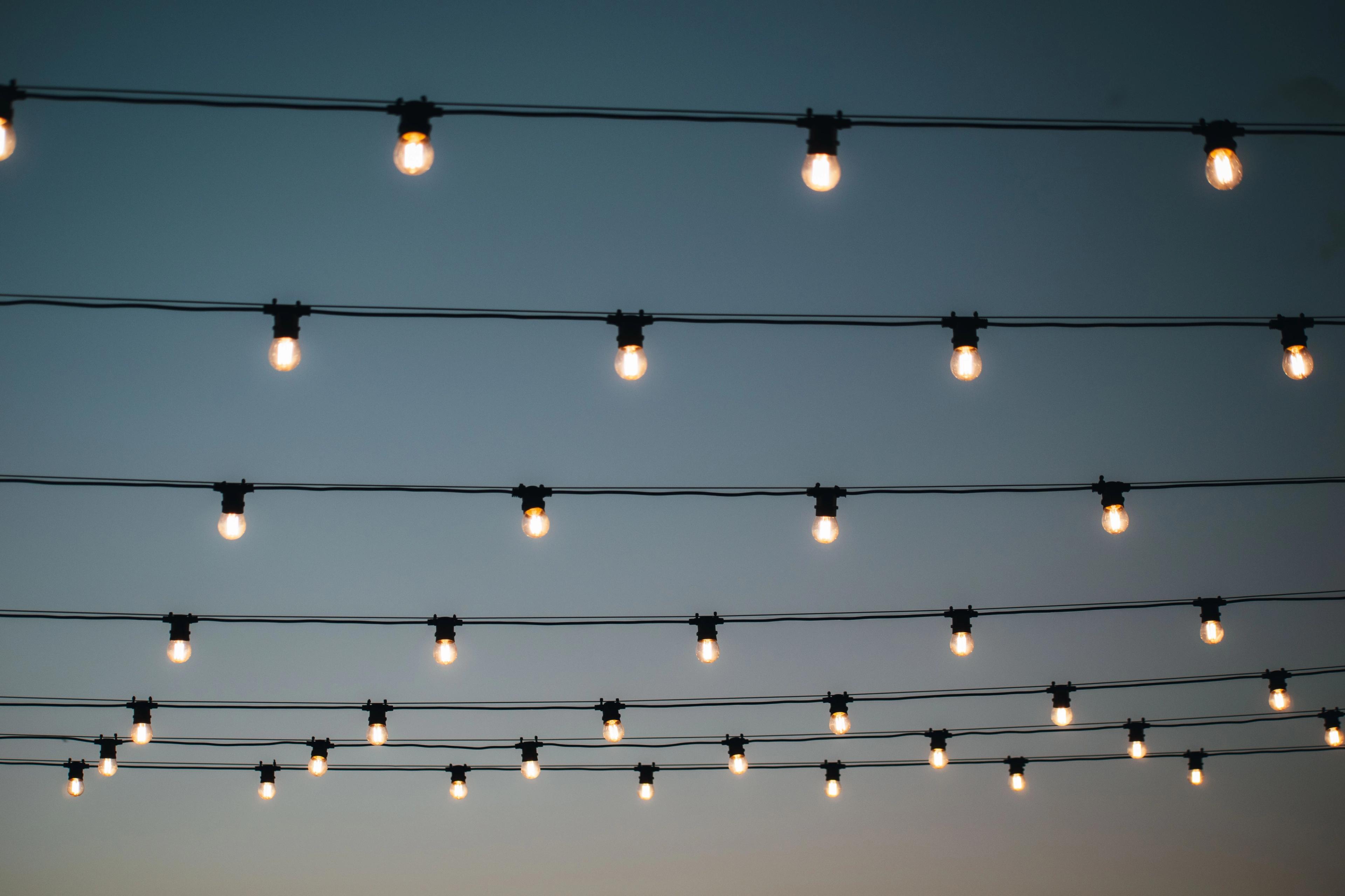 An image of festoon lighting and a twilight sky